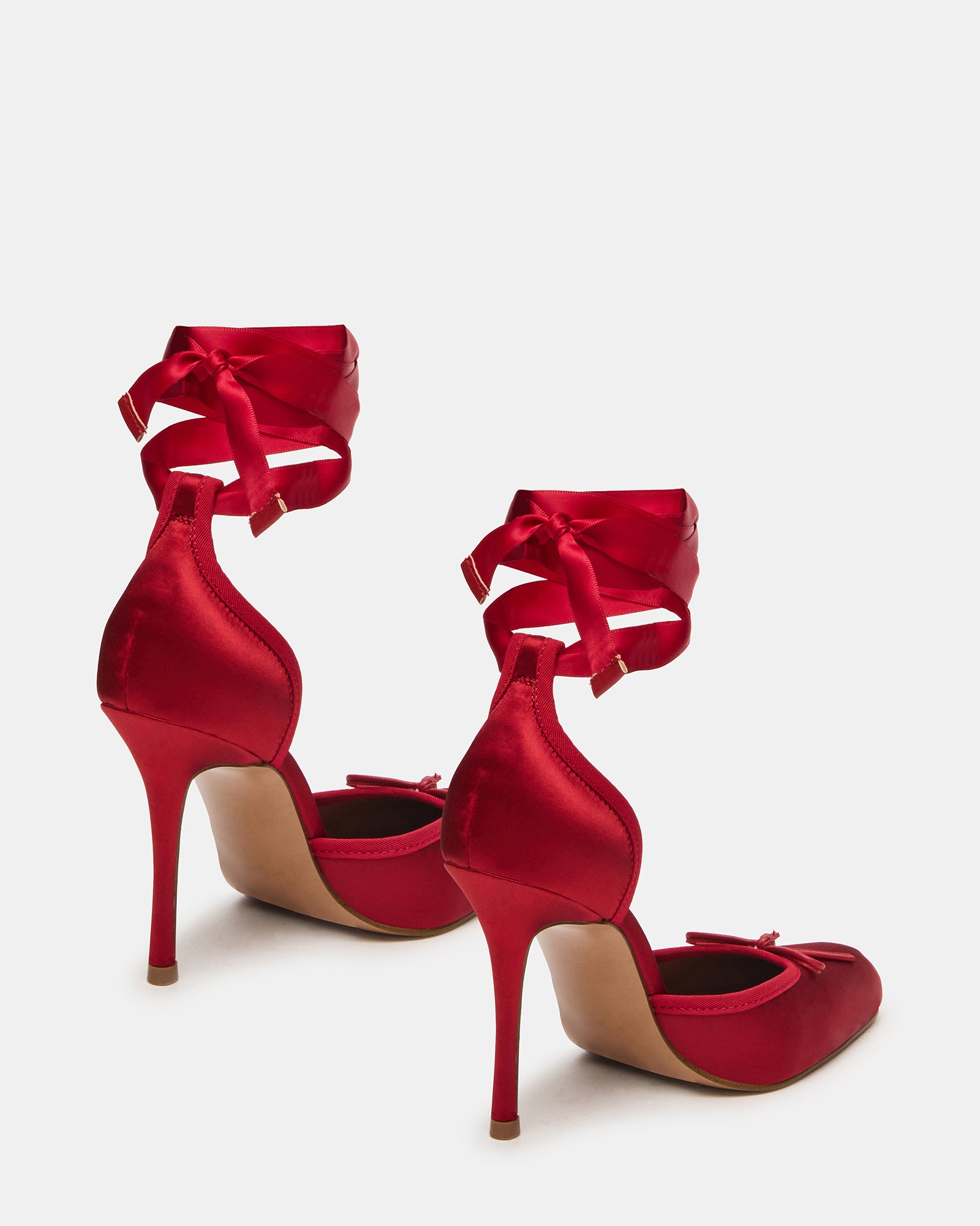 Side view of the block heel pumps, highlighting the intricate lace-up detail.