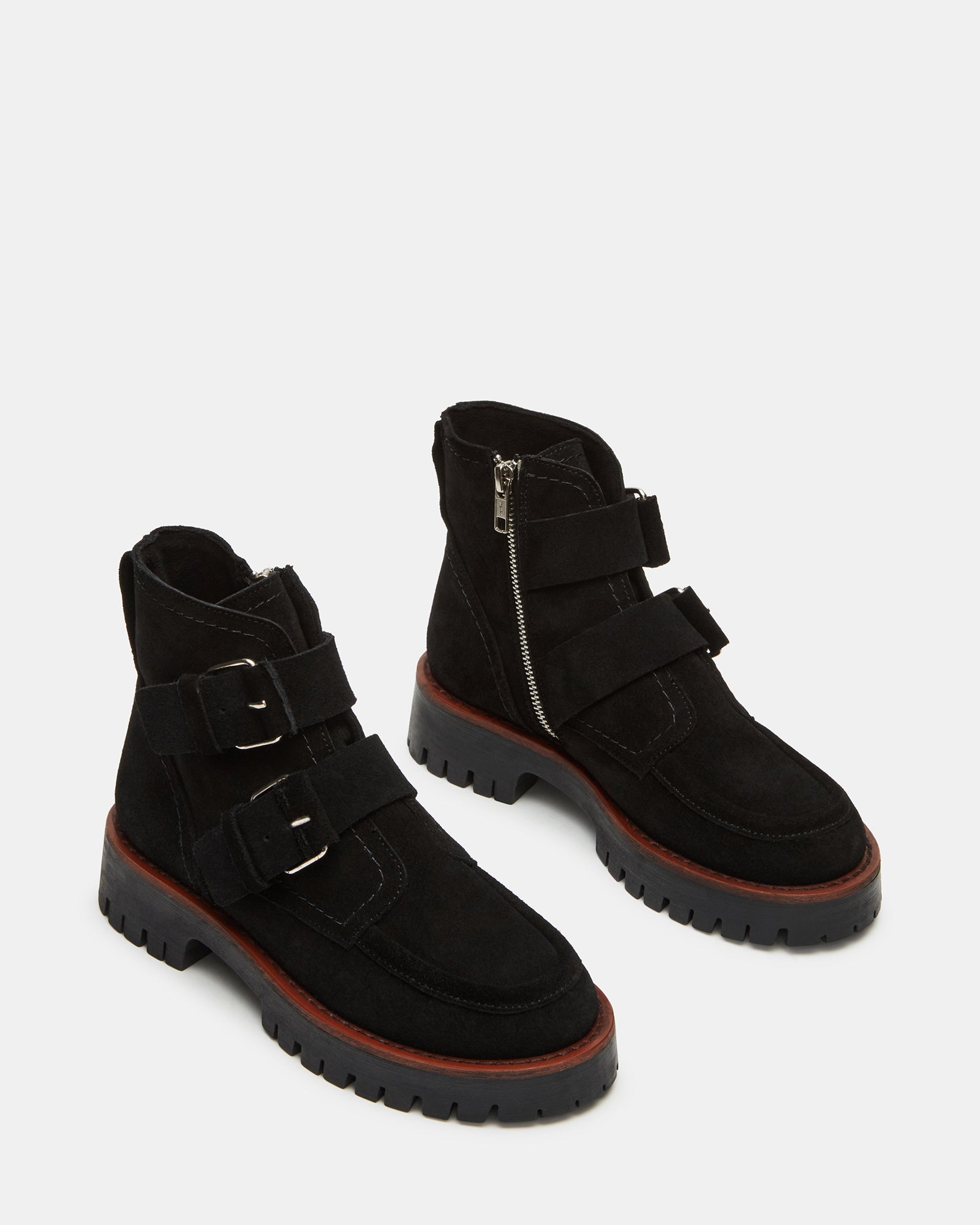 Lifestyle photo showing black over the knee suede boots paired with fall layers