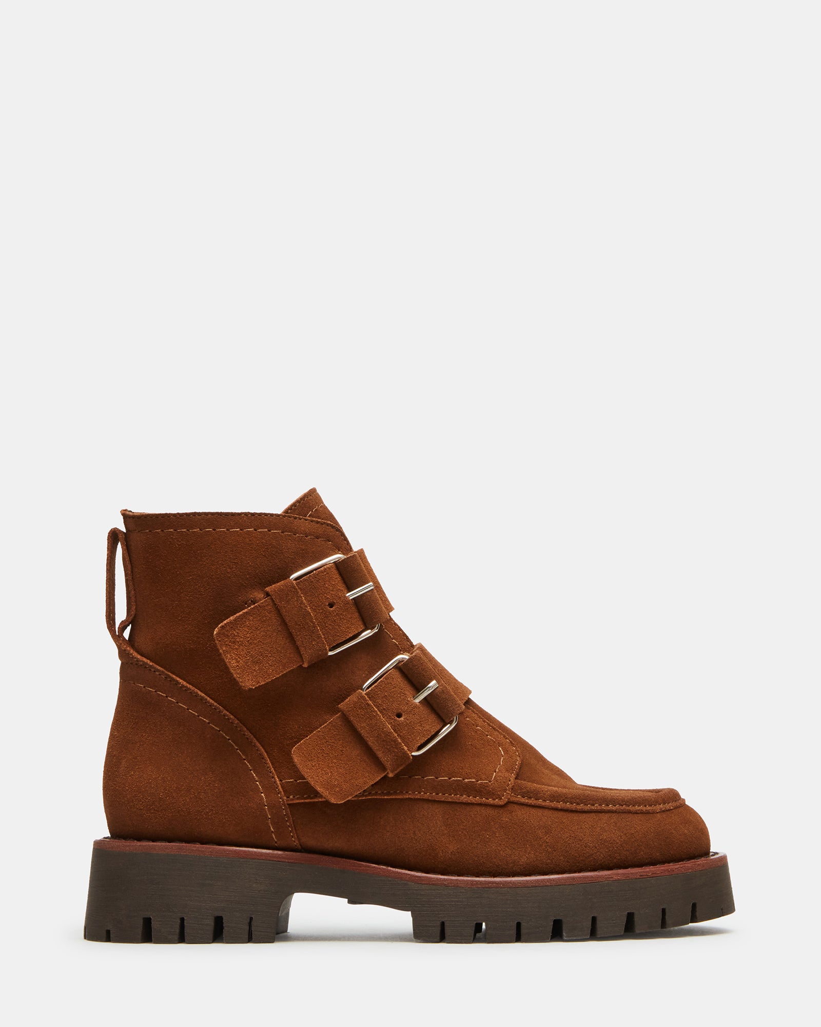 Brown suede ankle boots photographed from above, showing buckle detail and lug sole.