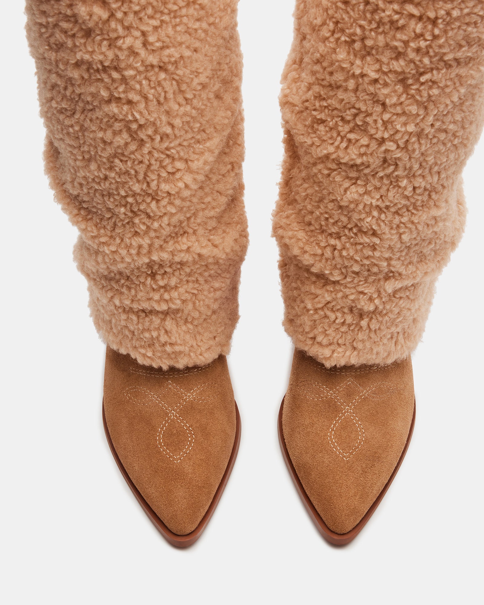 Close-up of decorative stitching on western style boots with point toe