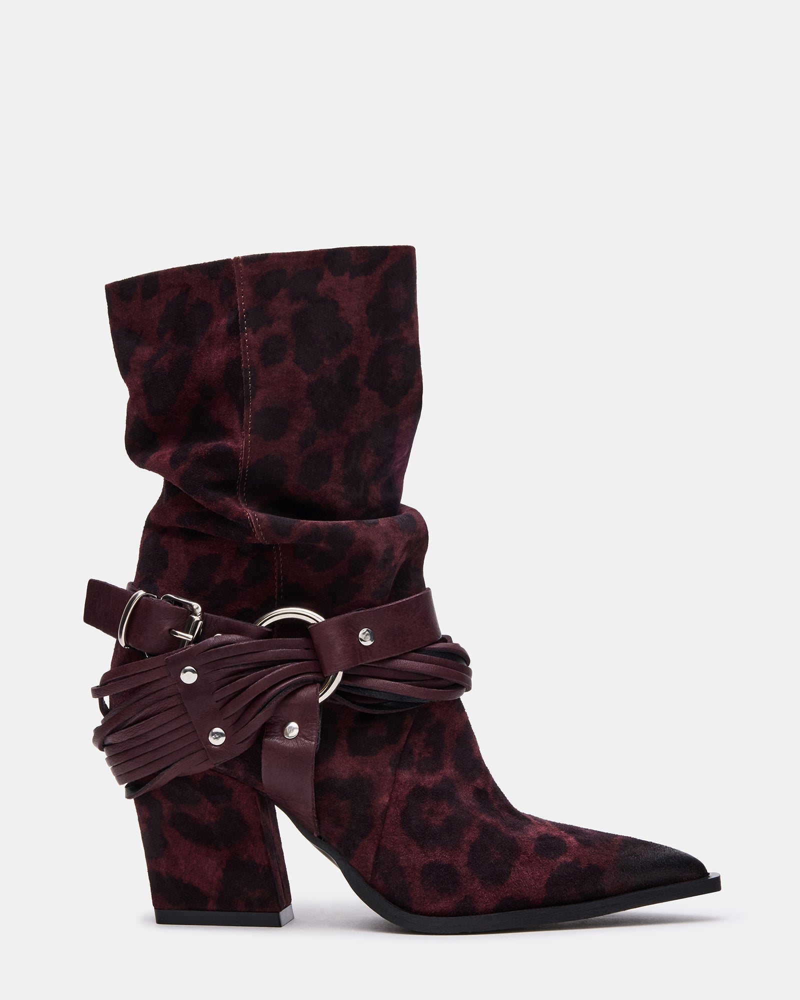 Leopard print boots on a wooden floor, showcasing pointed toe design.