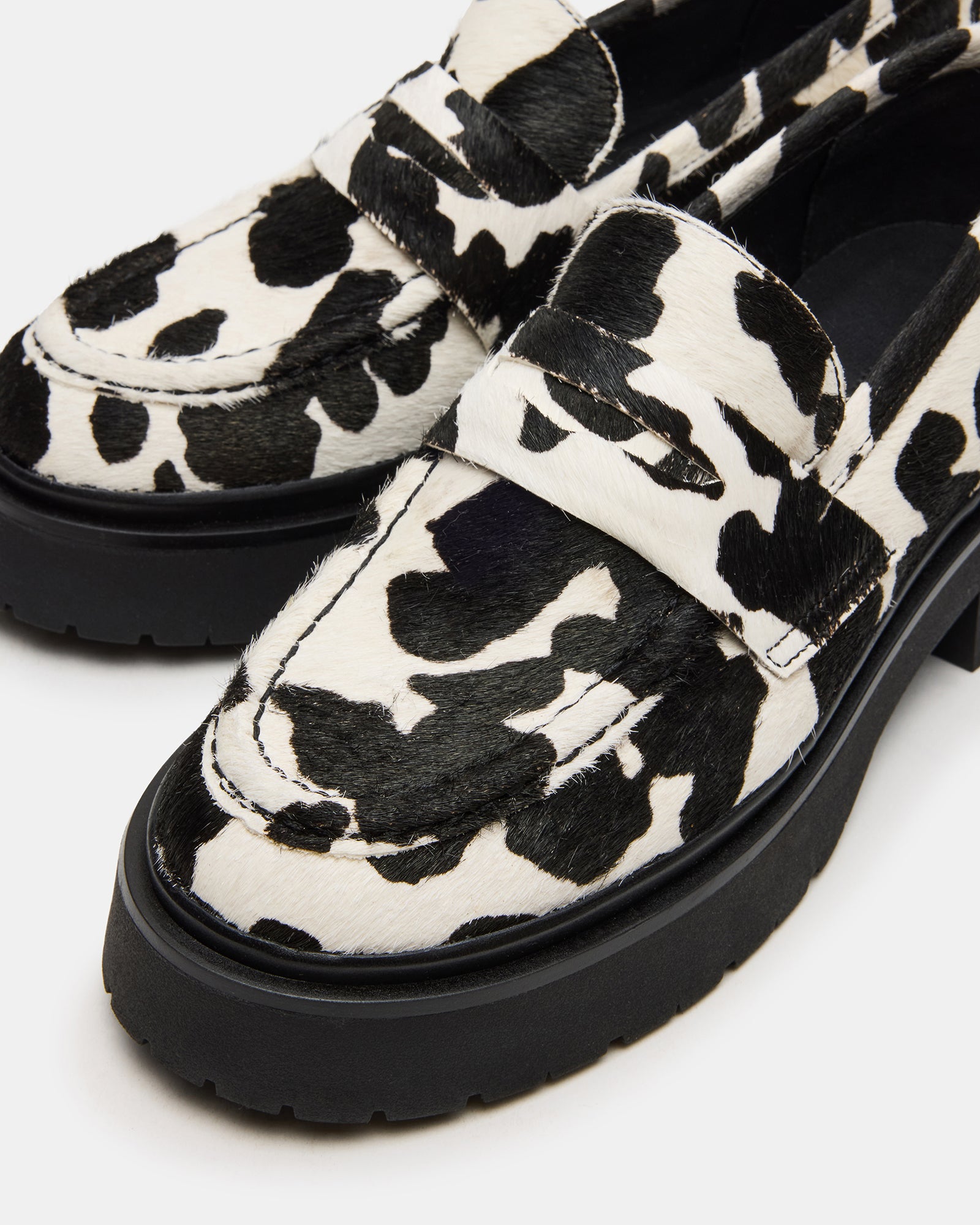Styled with cropped jeans on a Salt Lake City street, these brown leather loafers pop with flair