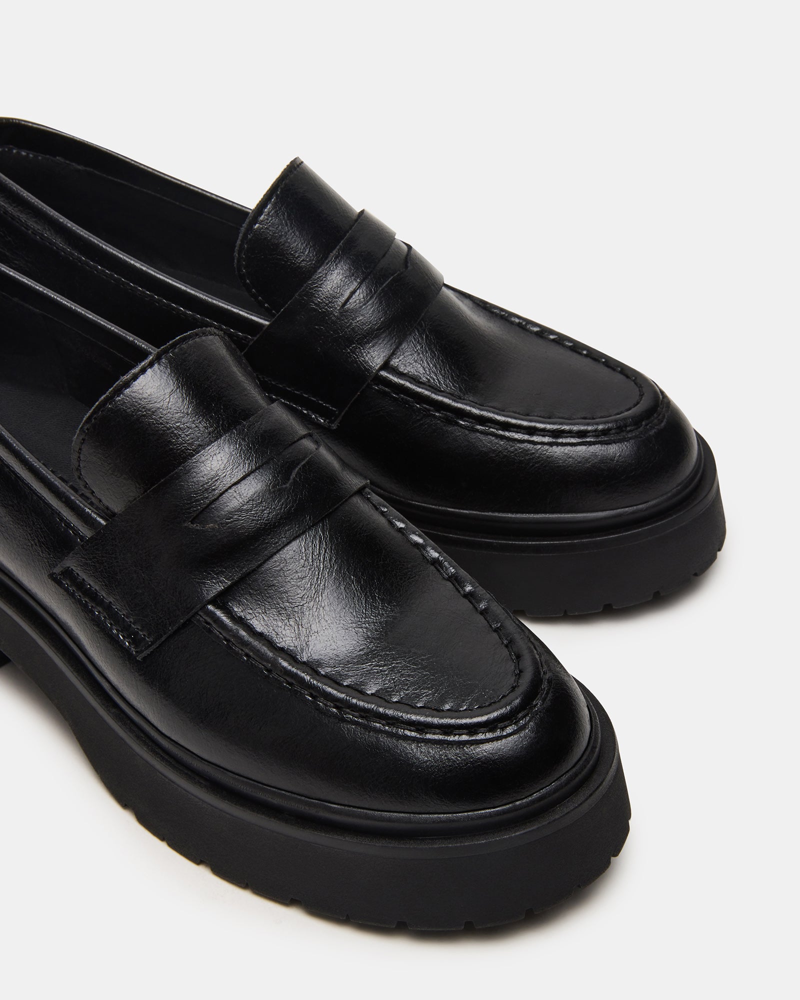 Model wearing black platform loafers with casual outfit