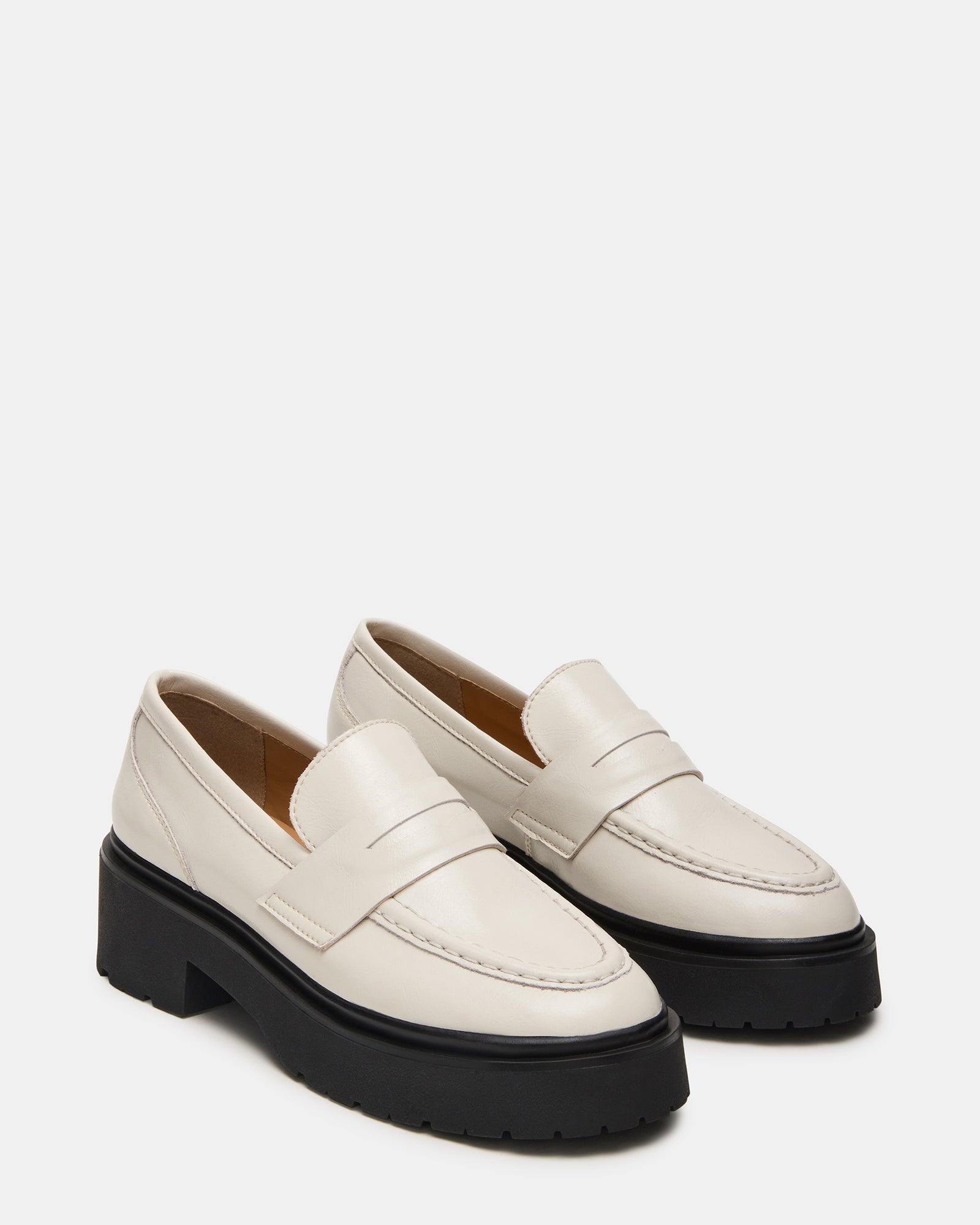 Brown leather loafers styled with rolled jeans for a casual look