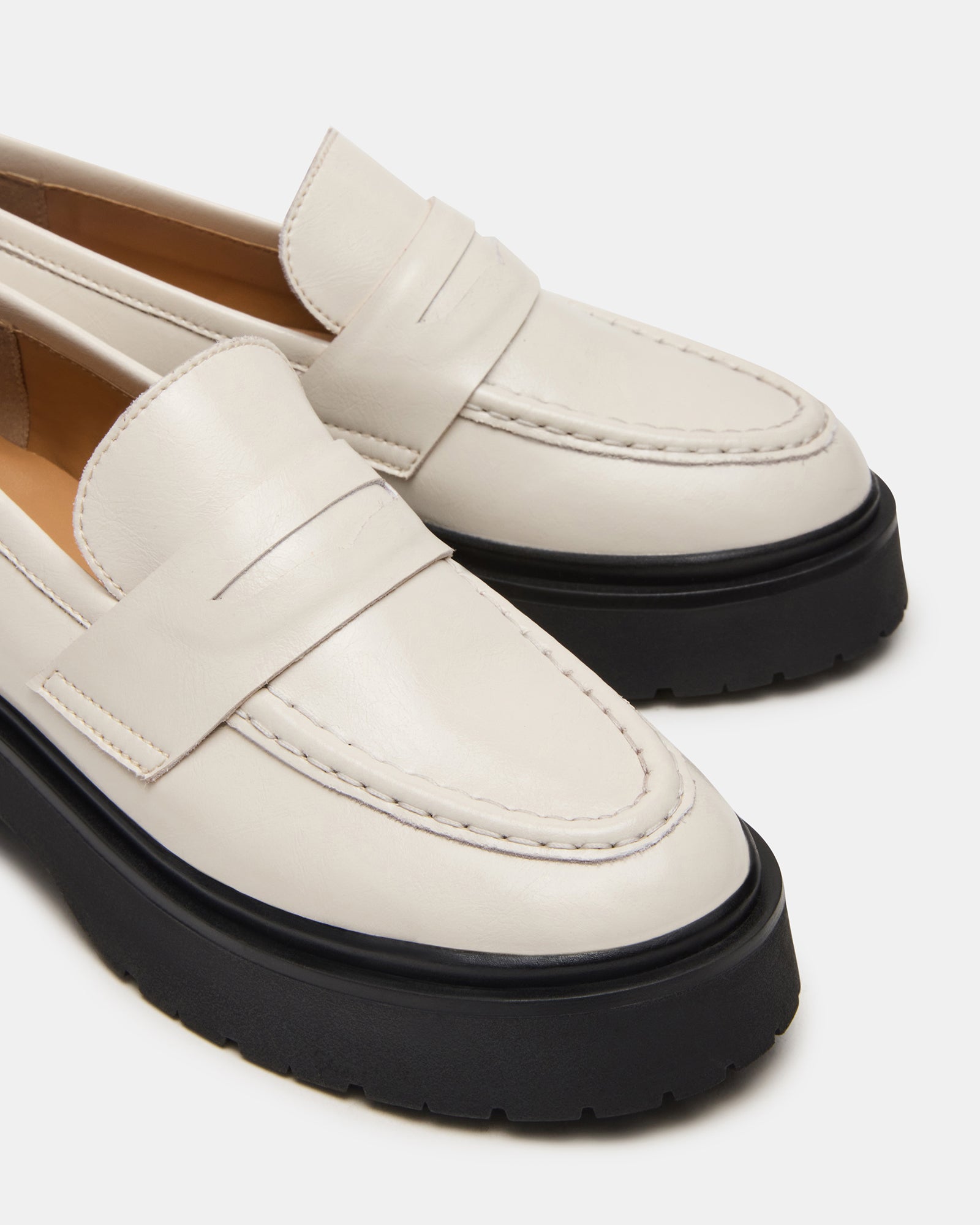 Close-up of patent leather loafers textured sole for traction