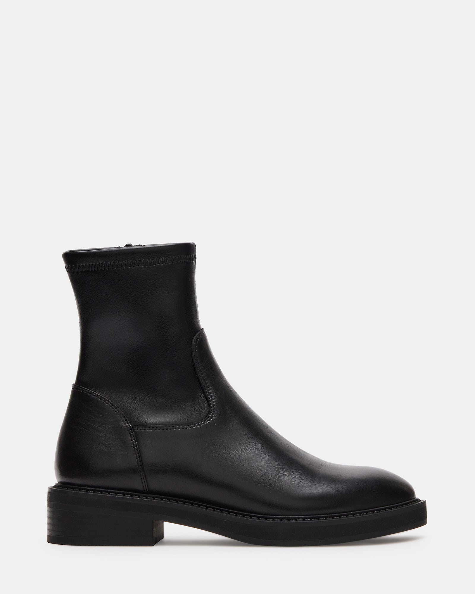 Side view of Lazio black leather ankle boots on a stylish woman in an urban setting