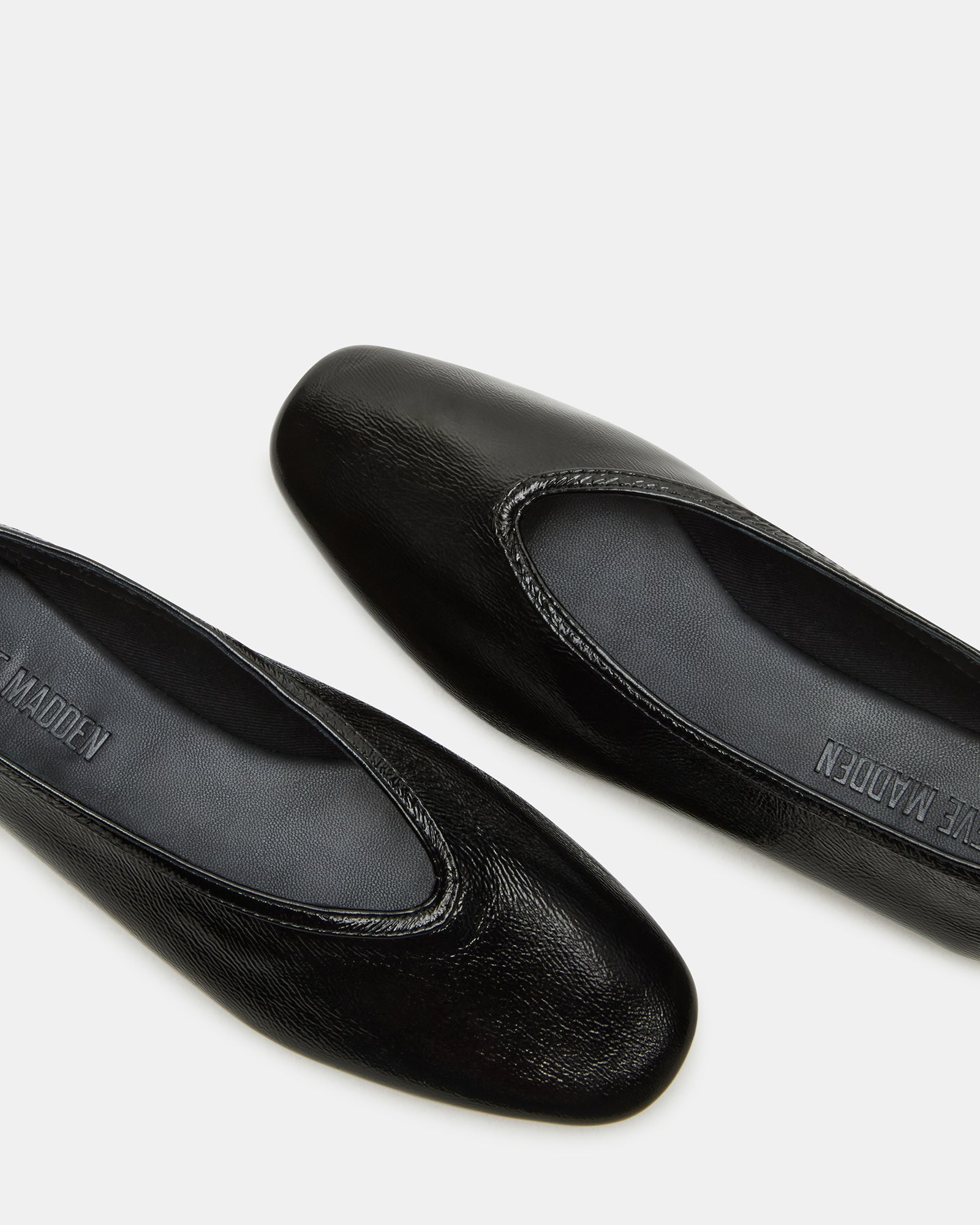 Side view of black ballet flats with sleek square toe