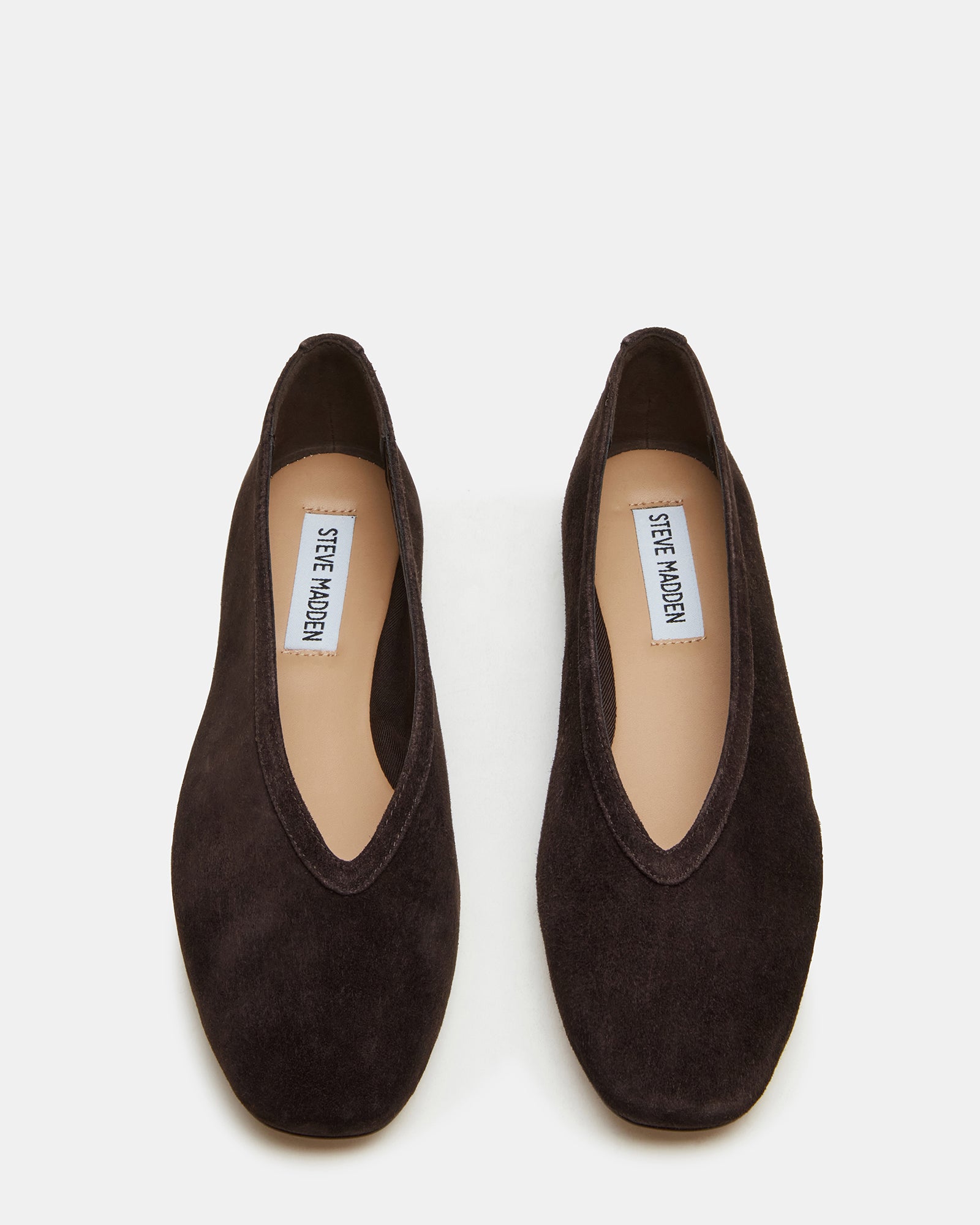 Pair of LENI suede flats styled with casual jeans and a blouse