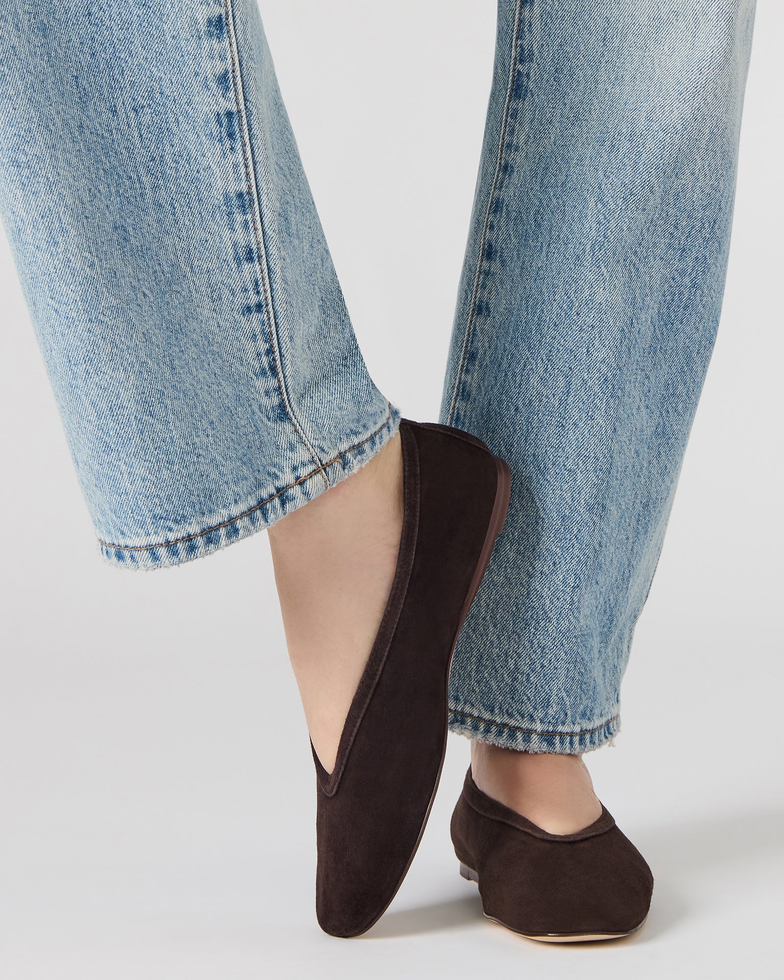 Pair of LENI suede flats styled with casual jeans and a blouse