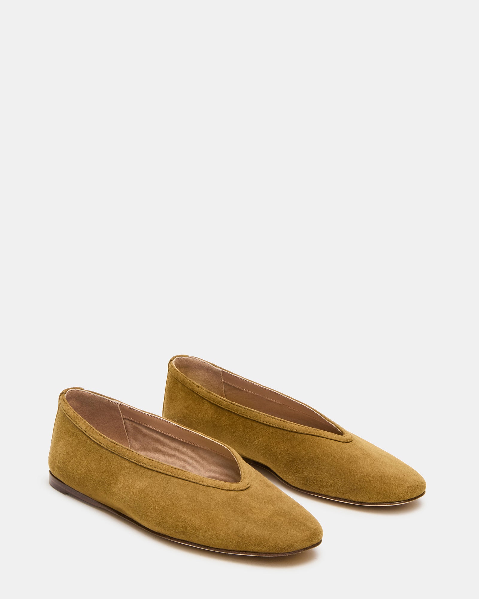 Model wearing mustard ballet flats in a casual outdoor setting, perfect for a day out.