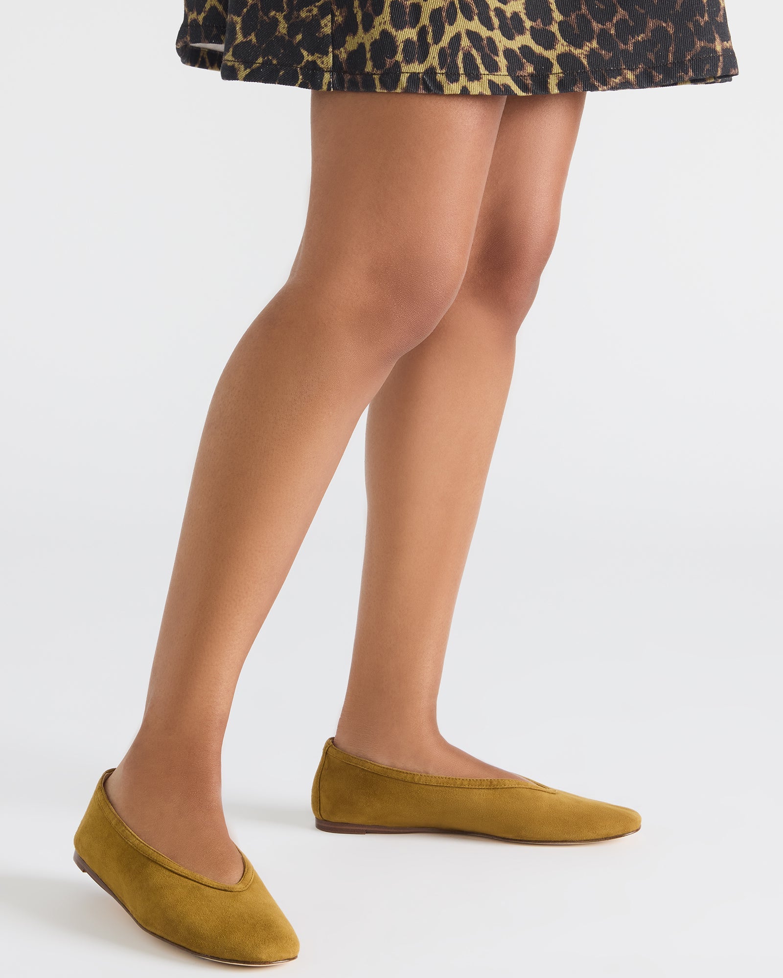 Top view of mustard suede ballet flats, showcasing the luxurious finish and comfortable fit.