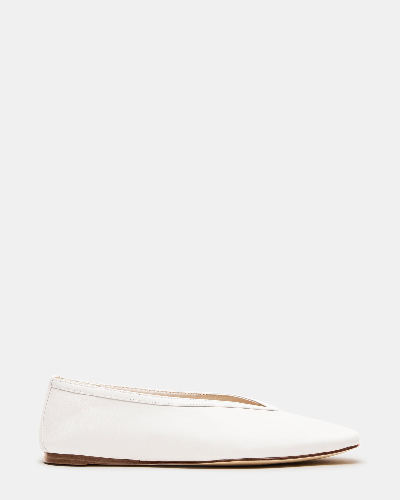 LENI white leather ballet flats paired with tailored trousers for a polished look