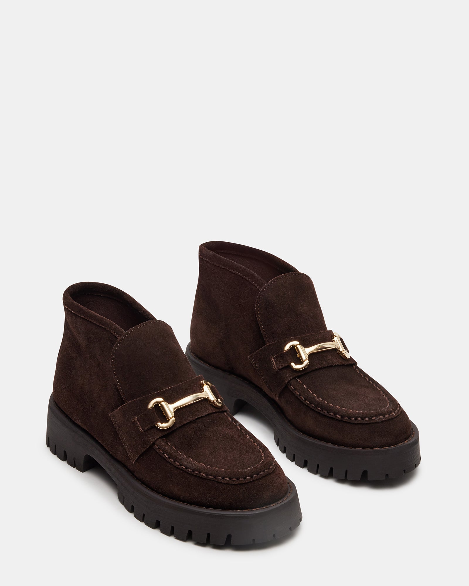 Close-up of suede texture and penny loafer design with hardware detailing, ideal for daily office style.