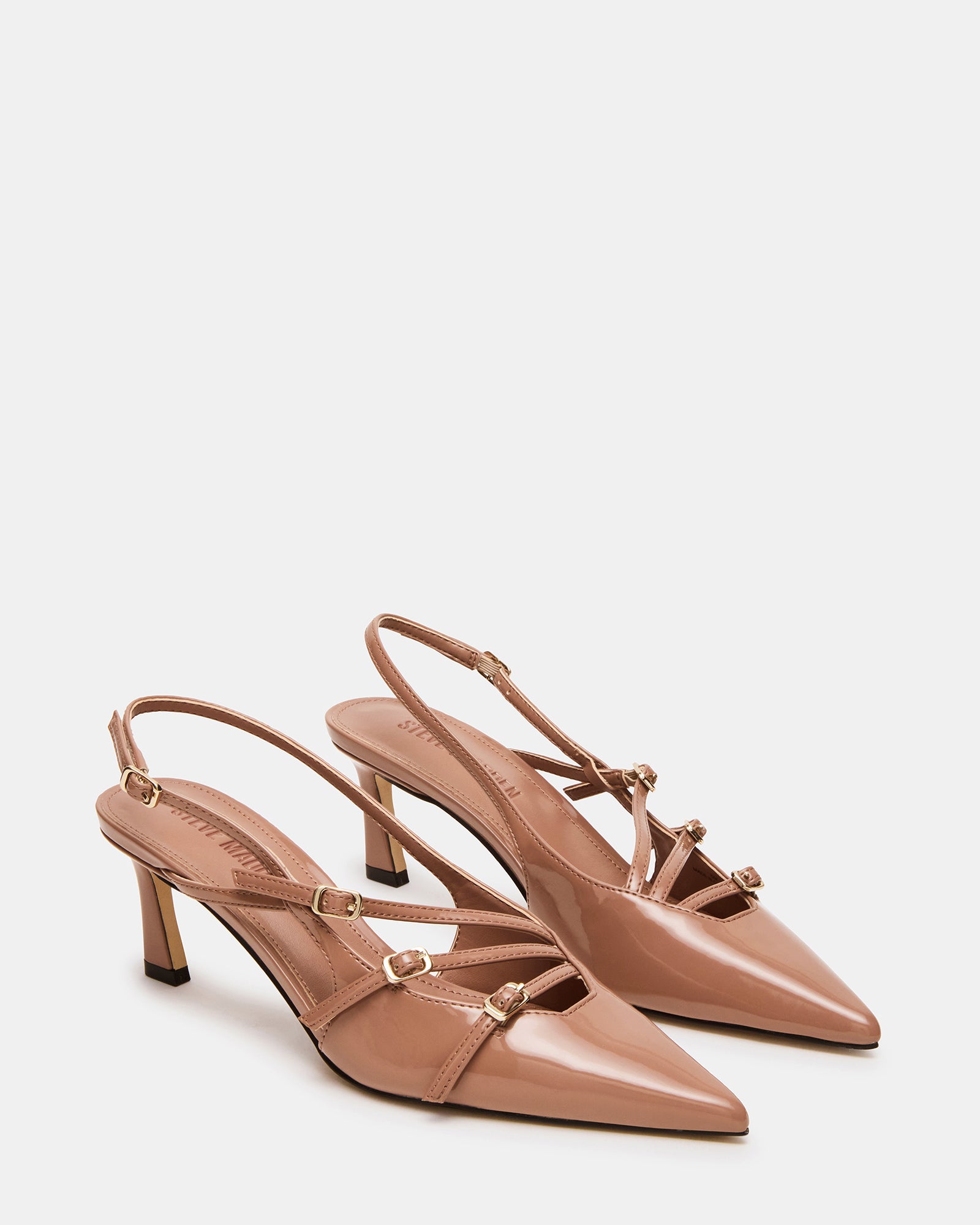 Close-up of silver slingback heels detailing the patent finish and elegant straps