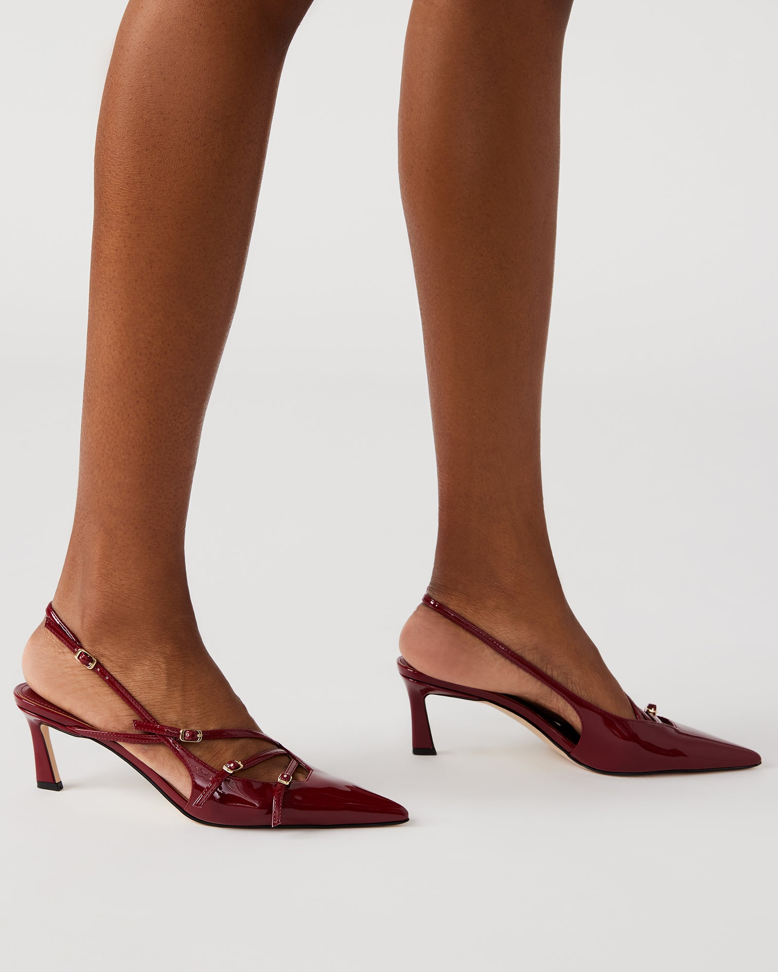 Front view of luxury womens shoes with strappy design and glossy finish