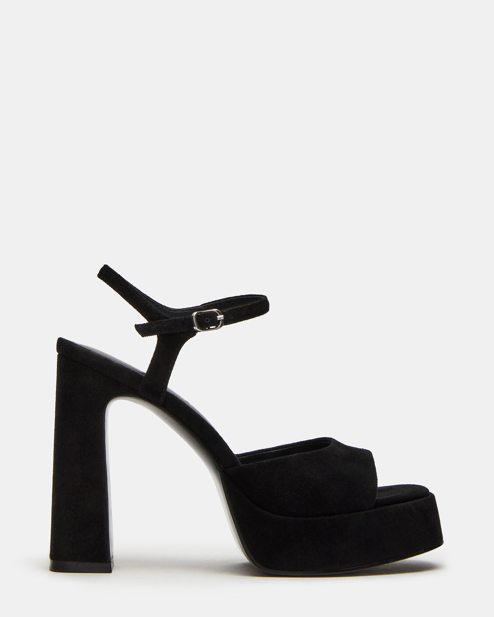 Side view of black suede platform shoes with block heels, styled for city wear.