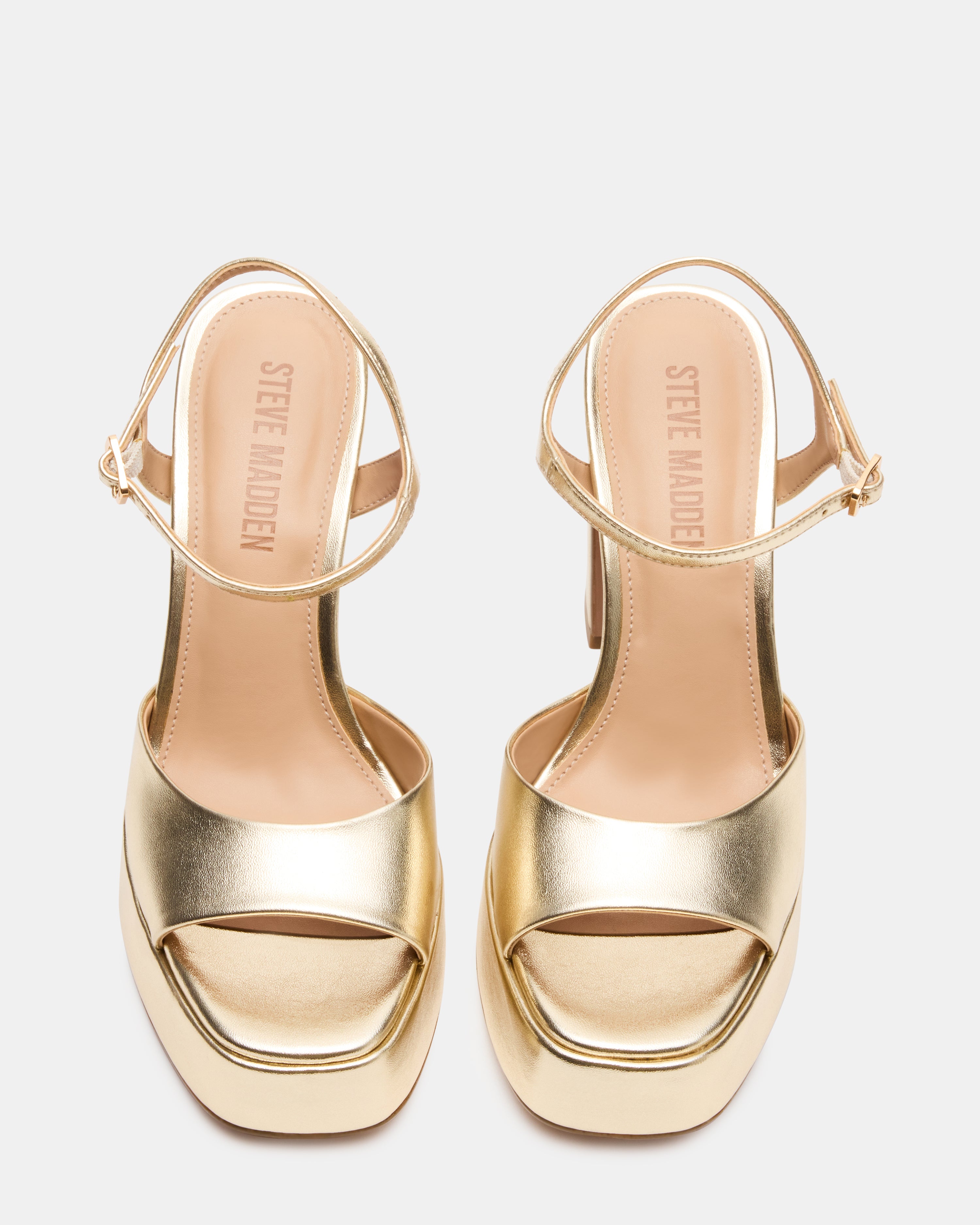 Front angle view of platform block heel shoes with champagne finish