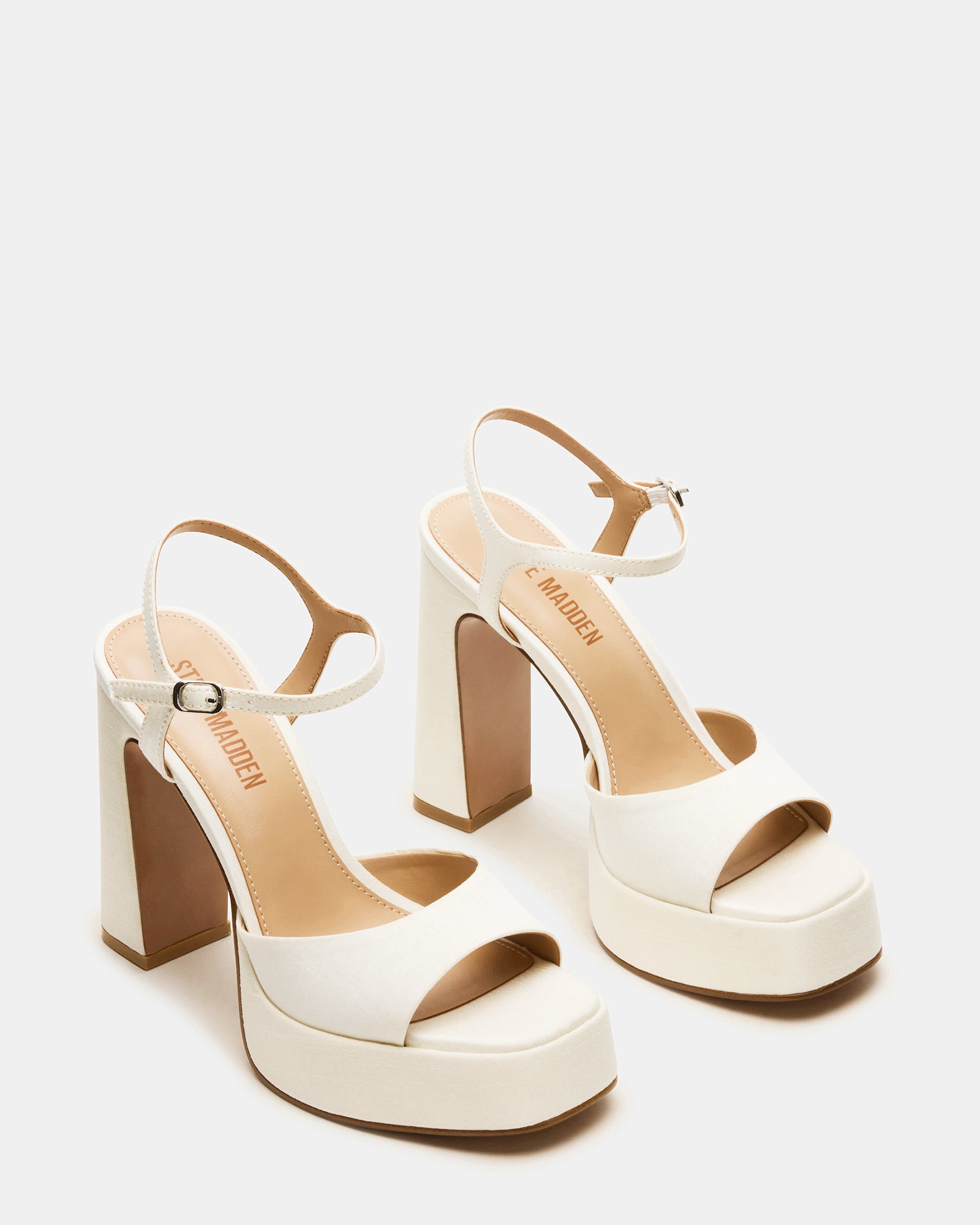 Ivory satin platform block heels styled with a chic outfit for a night out.