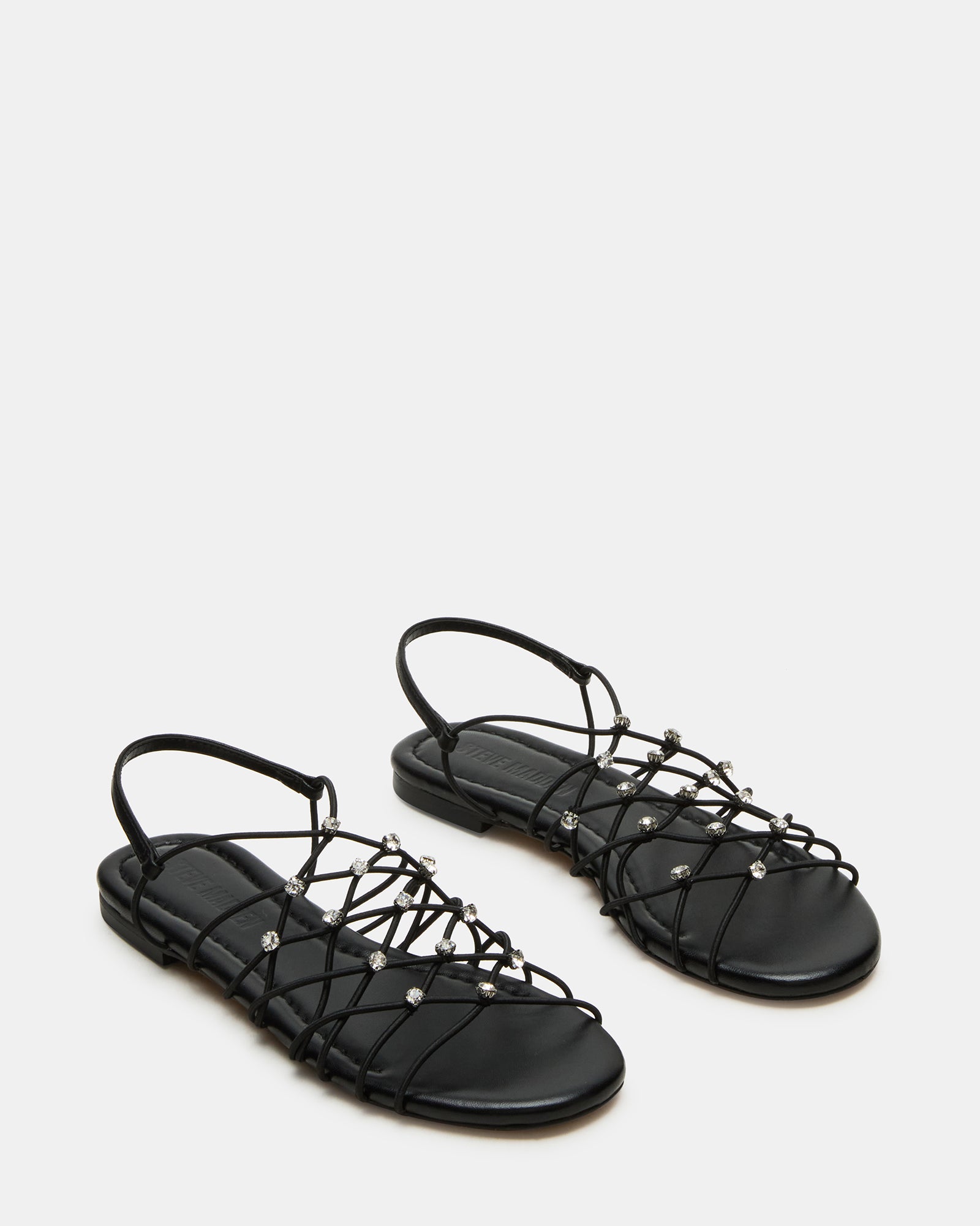 Side view of black flat sandals perfect for casual outings.