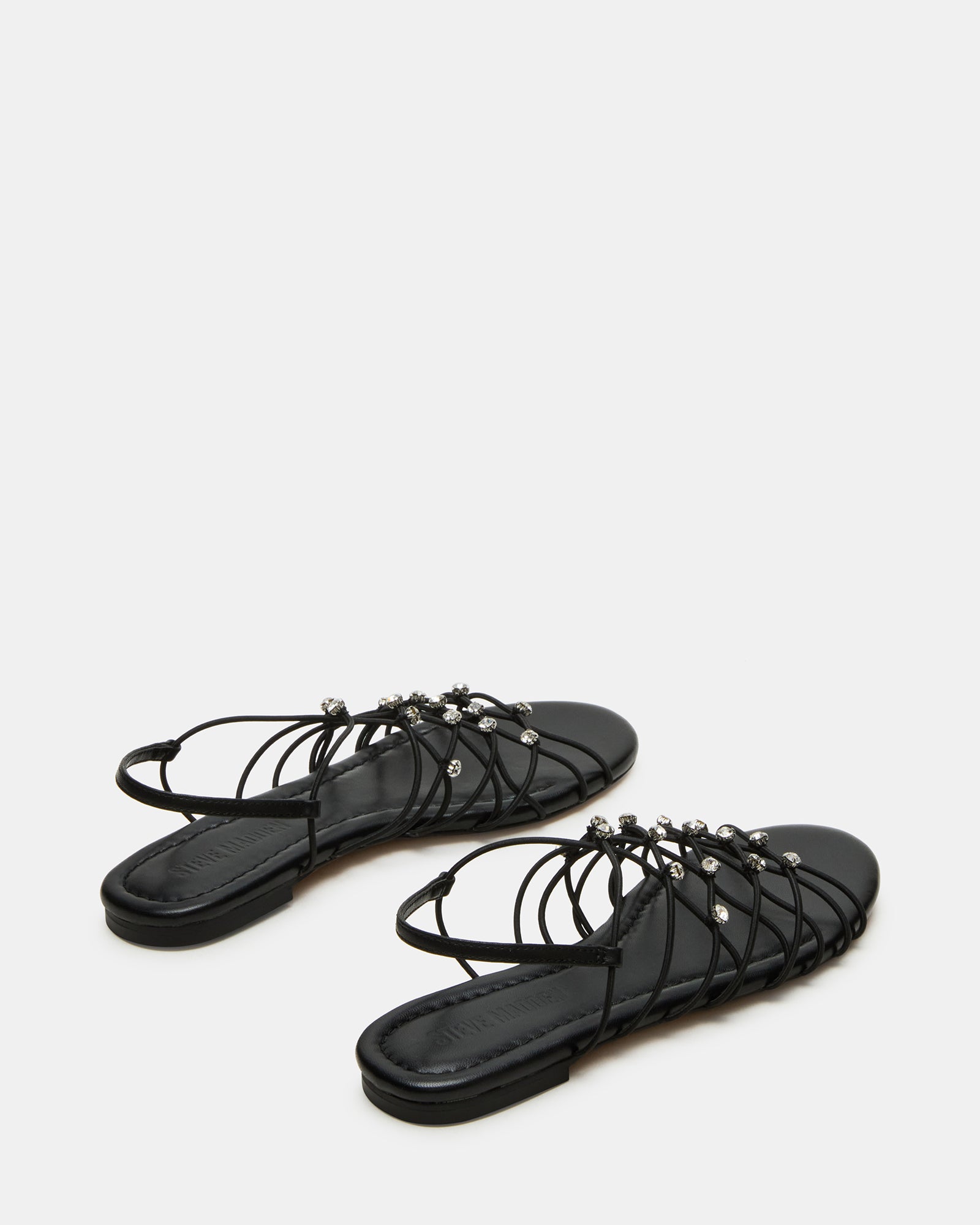 Side view of black flat sandals perfect for casual outings.