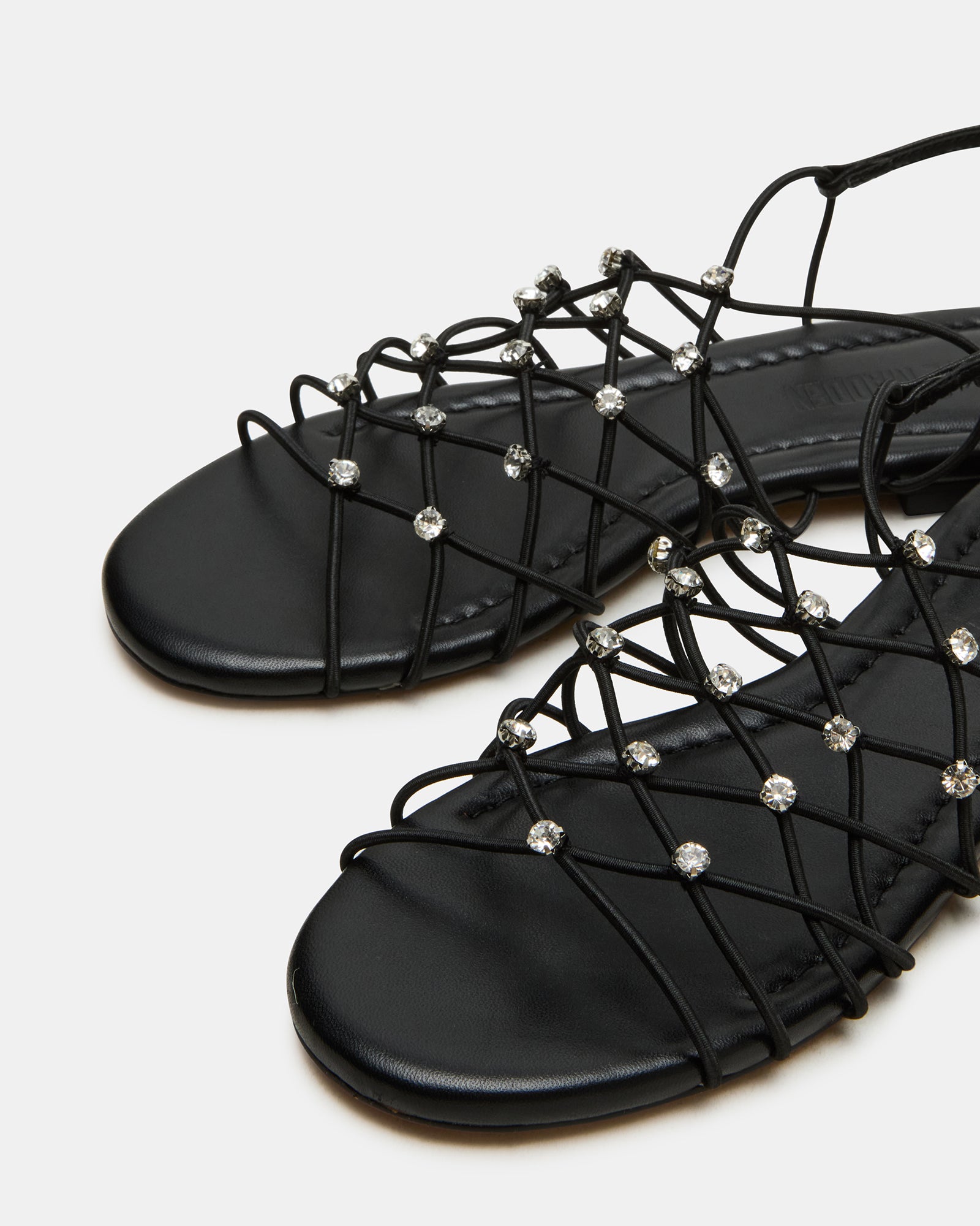 Model wearing Libra sandals at a summer event, highlighting their elegance.