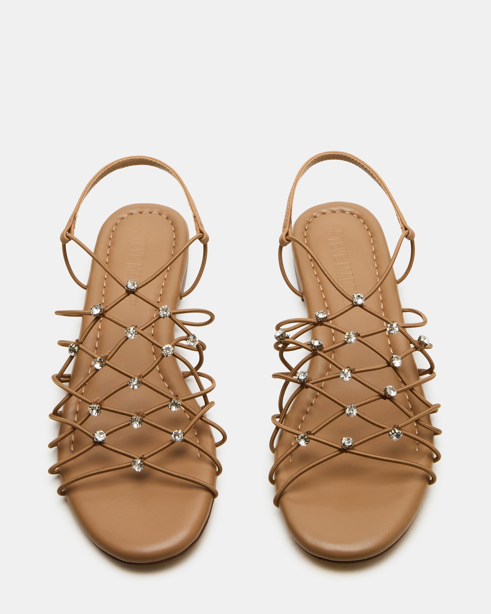 Close-up of natural rhinestone detailing on nude strappy sandals