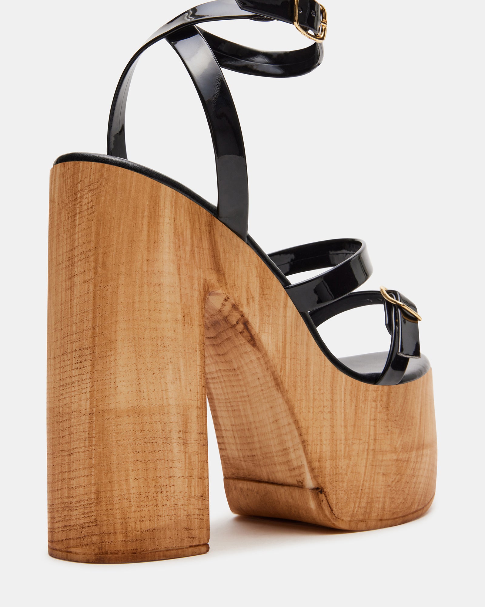 Close-up of ankle strap detail on black patent heels for support and style
