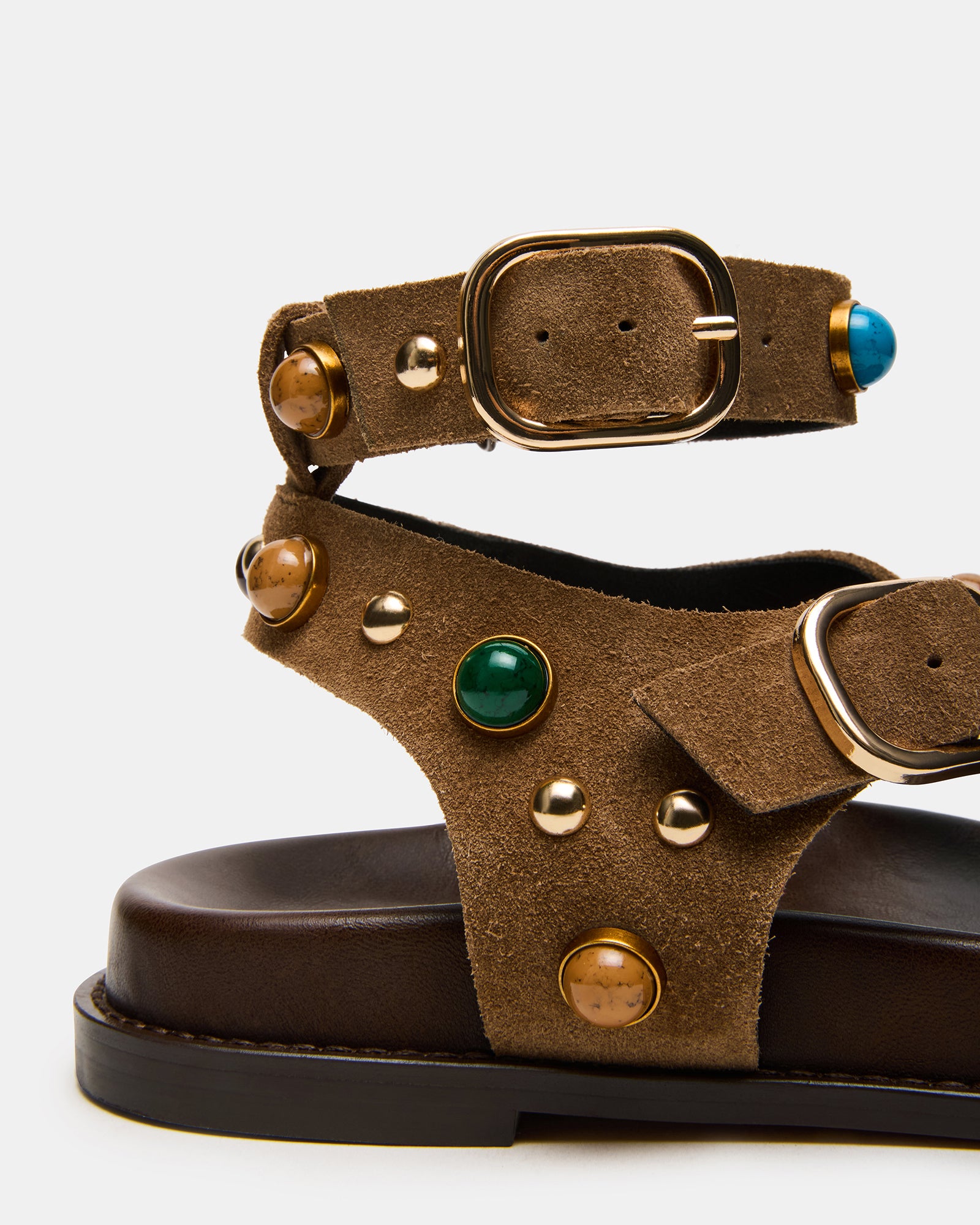 Side view of taupe suede ankle strap flat sandals showcasing the secure strap.
