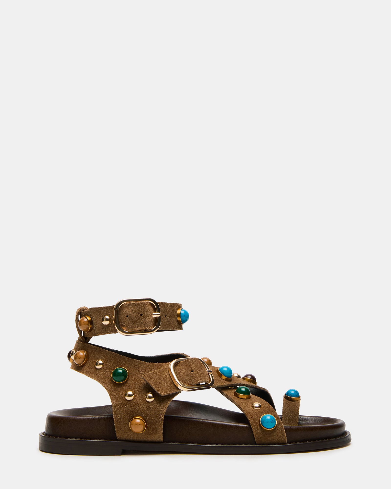 Side view of taupe suede ankle strap flat sandals showcasing the secure strap.