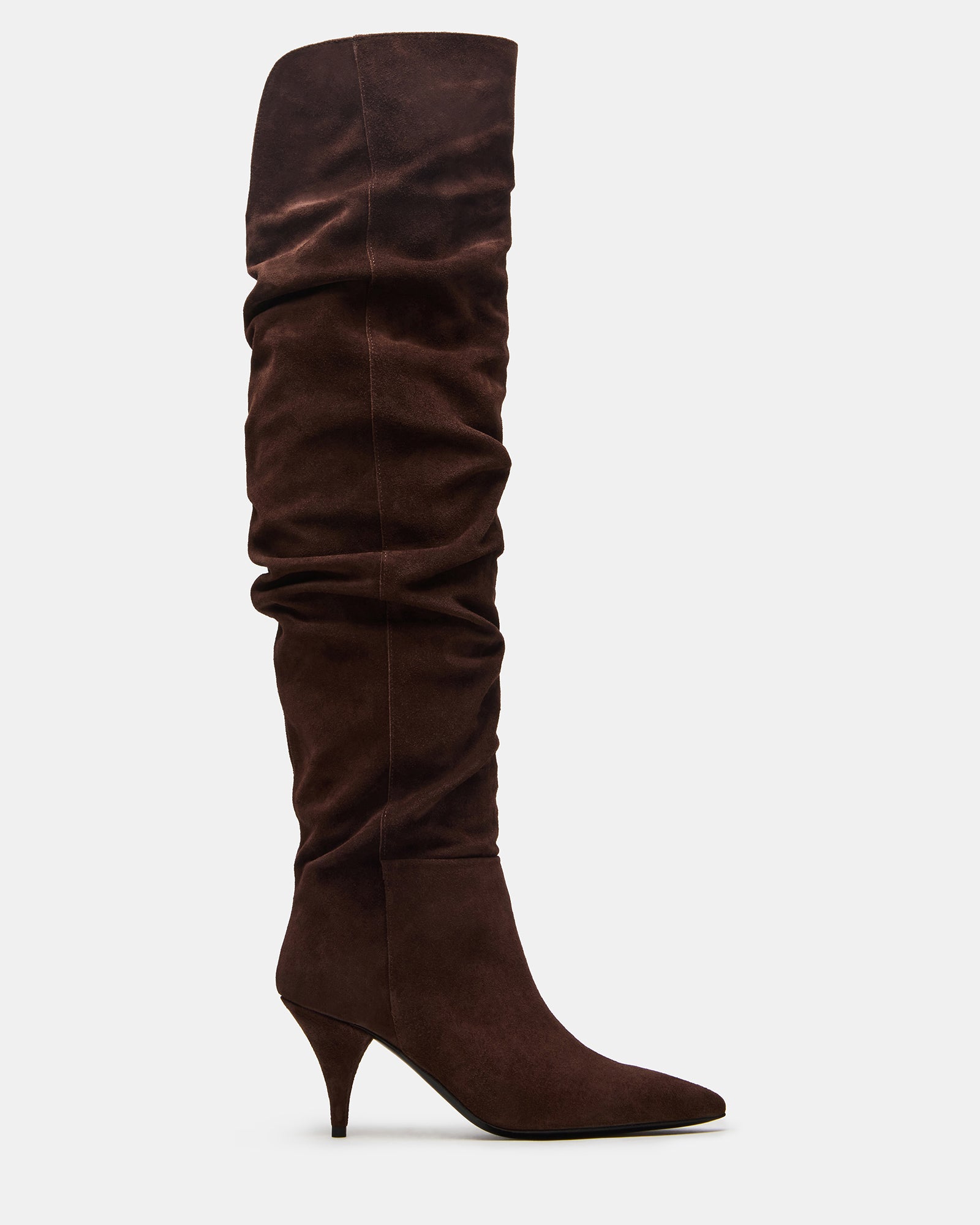 Brown suede over-the-knee boots styled with a mini dress for a night out.