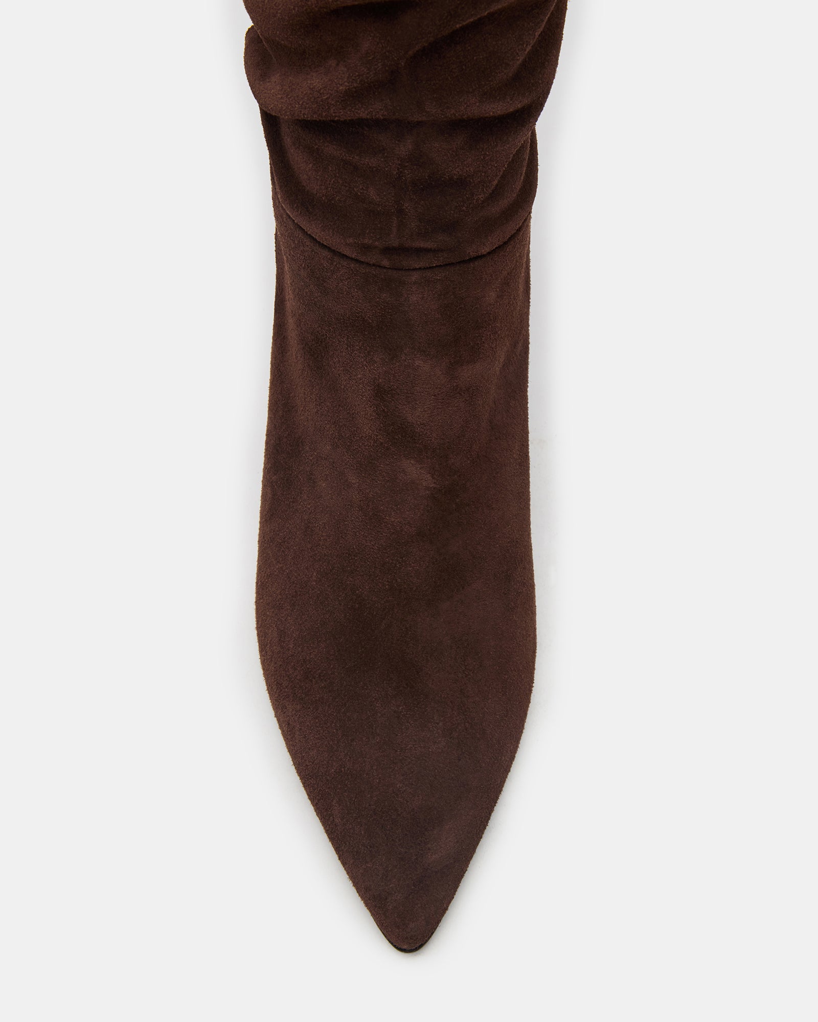 Brown suede over-the-knee boots styled with a mini dress for a night out.