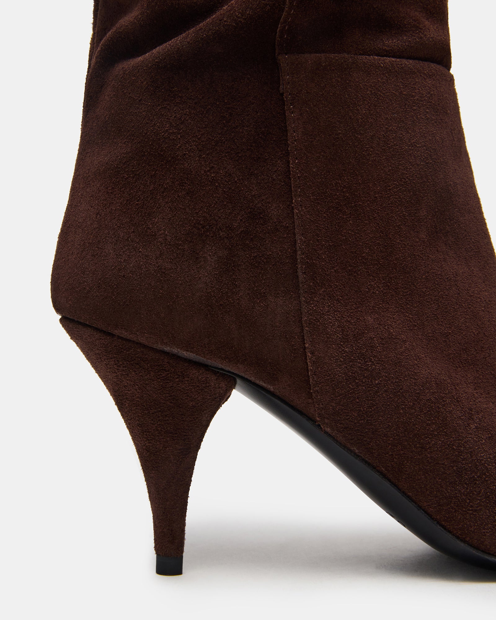 Side view of the boots showing the suede texture and over-the-knee fit.