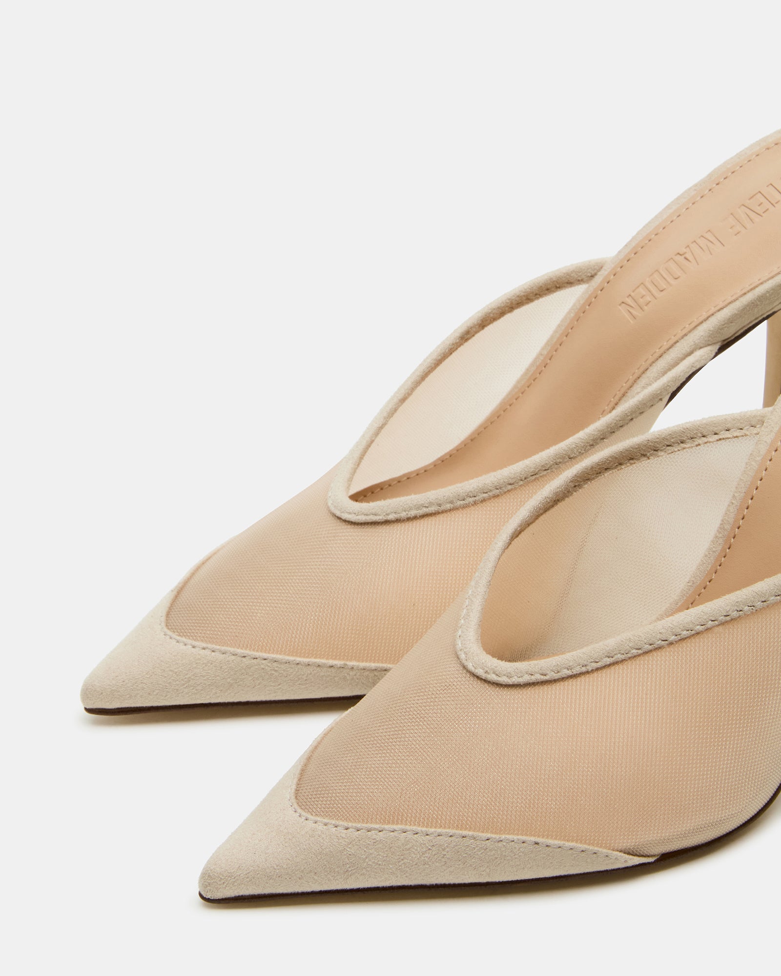 Lifestyle image featuring pointed toe heeled mules worn with tailored jeans