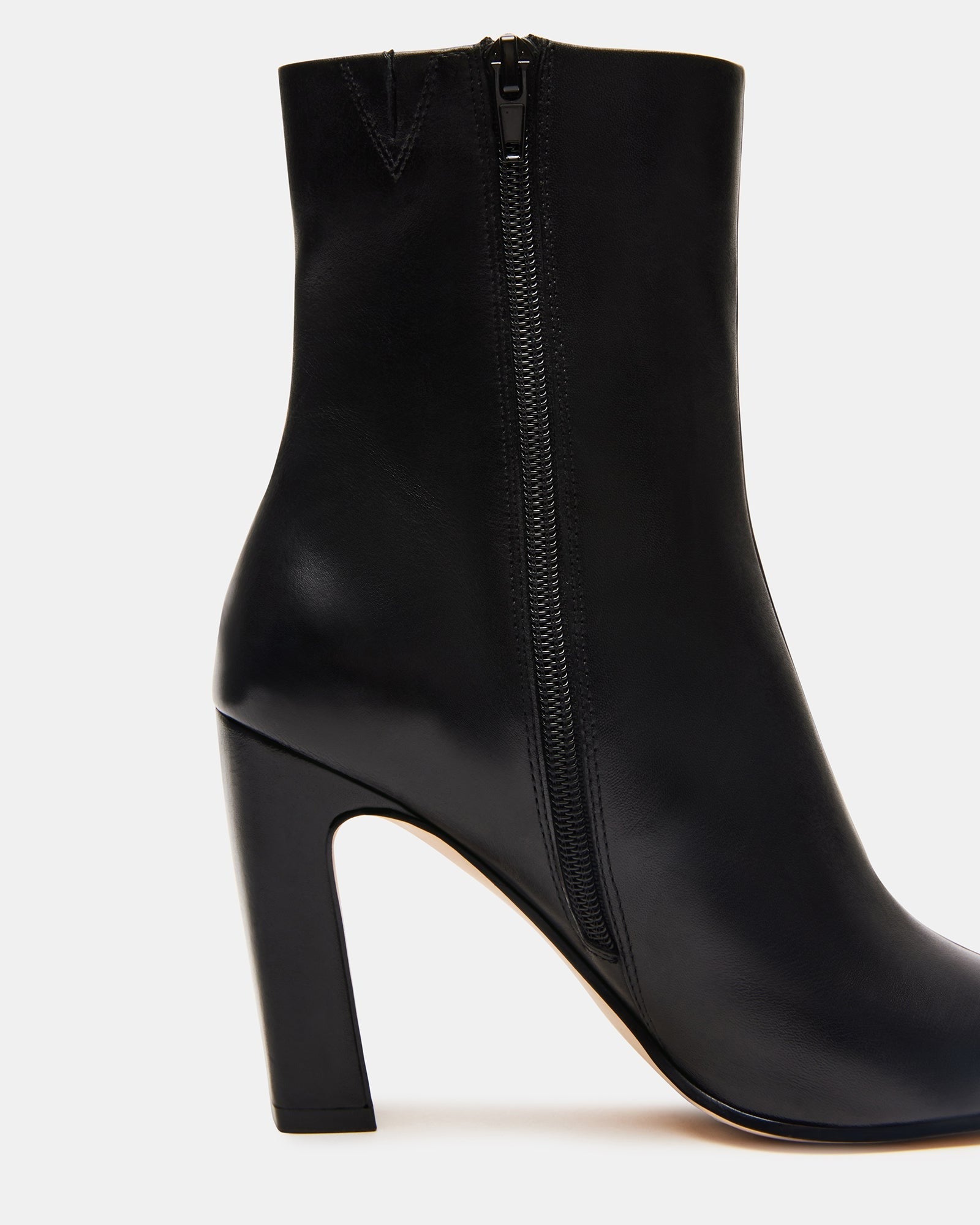 Top-down view of black ankle boots highlighting square toe design.