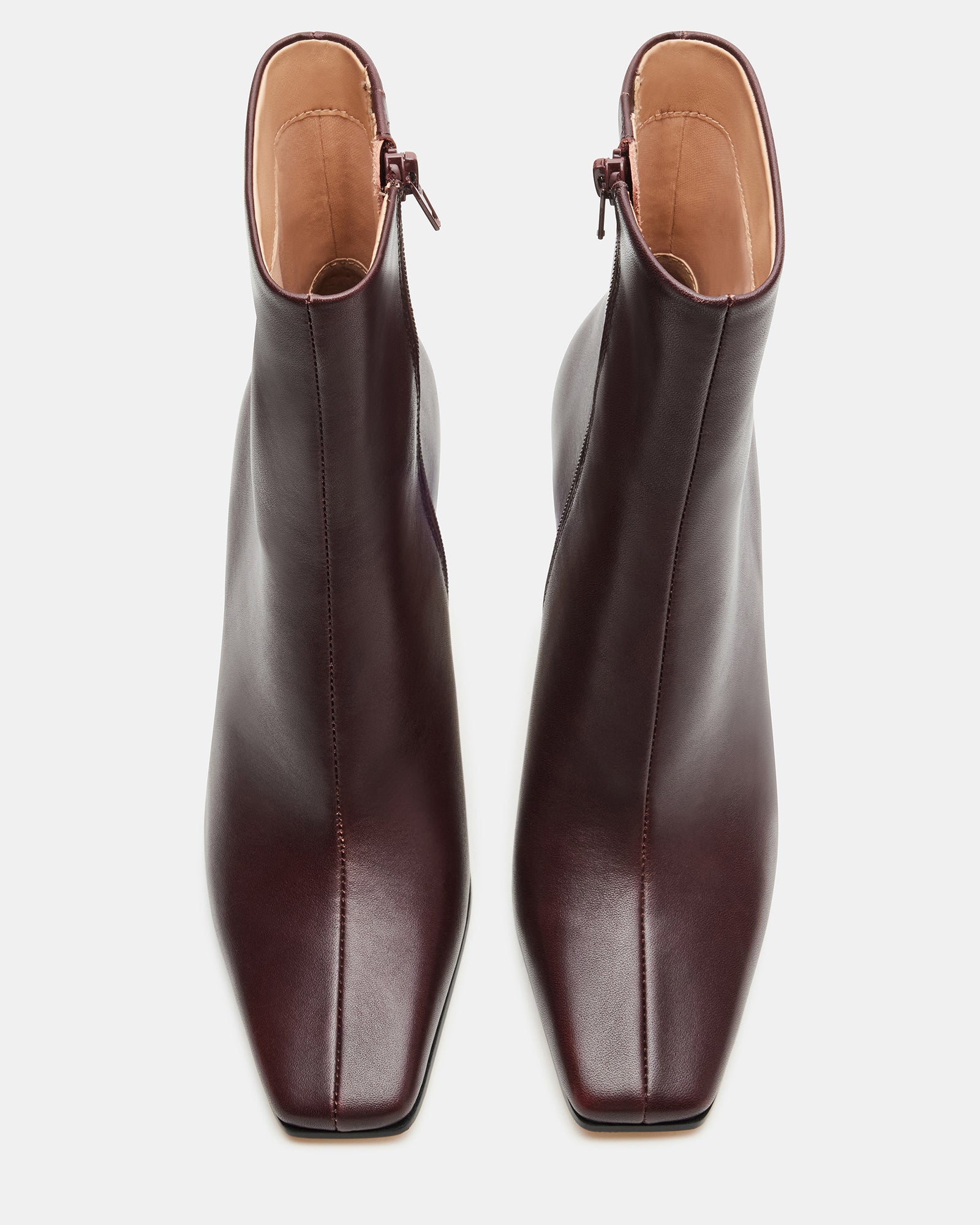 Top-down view of square toe boots styled with cropped jeans in New Orleans setting