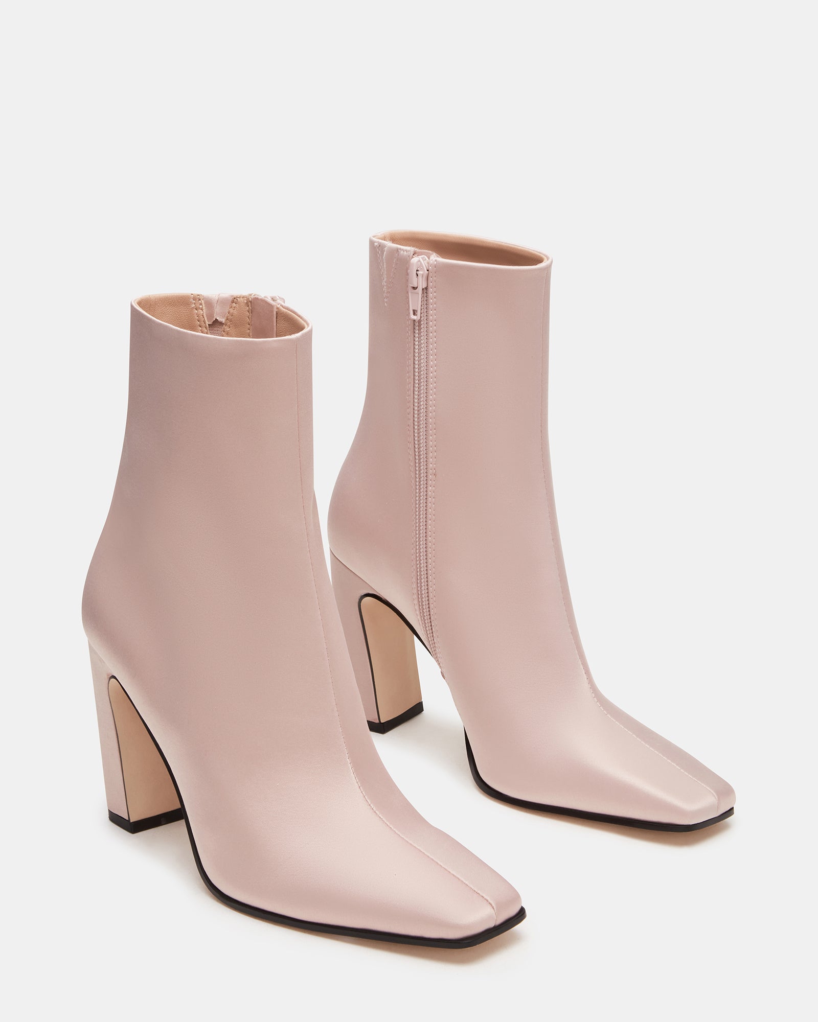 Side profile of fashion booties highlighting heel height and shaft structure