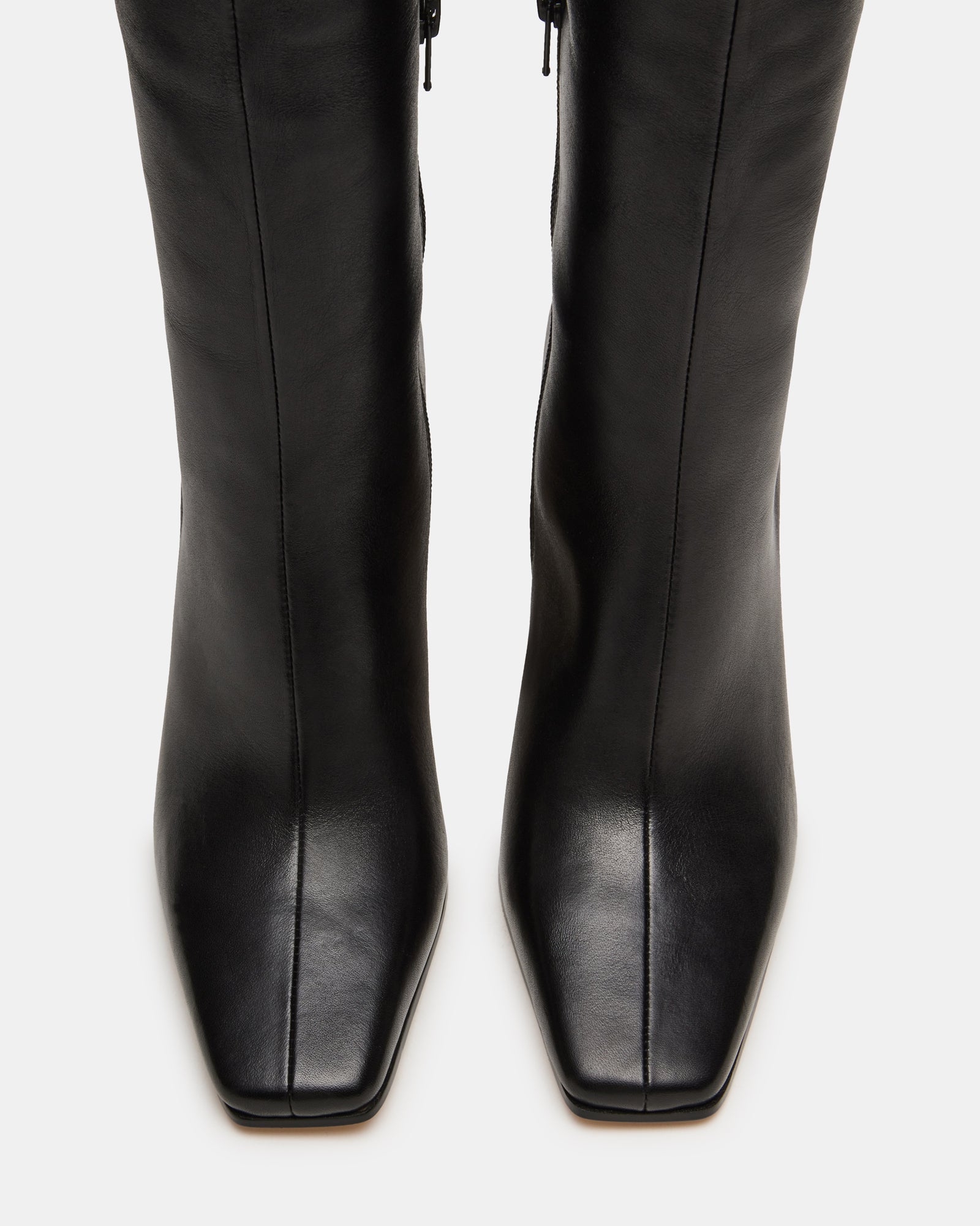 Close-up of heel and square toe of wide calf knee-high boots in black