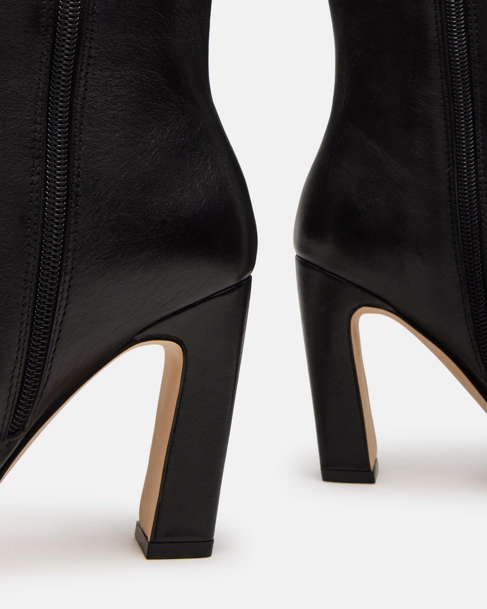 Side view of black leather knee-high boots showing wide boot calf fit