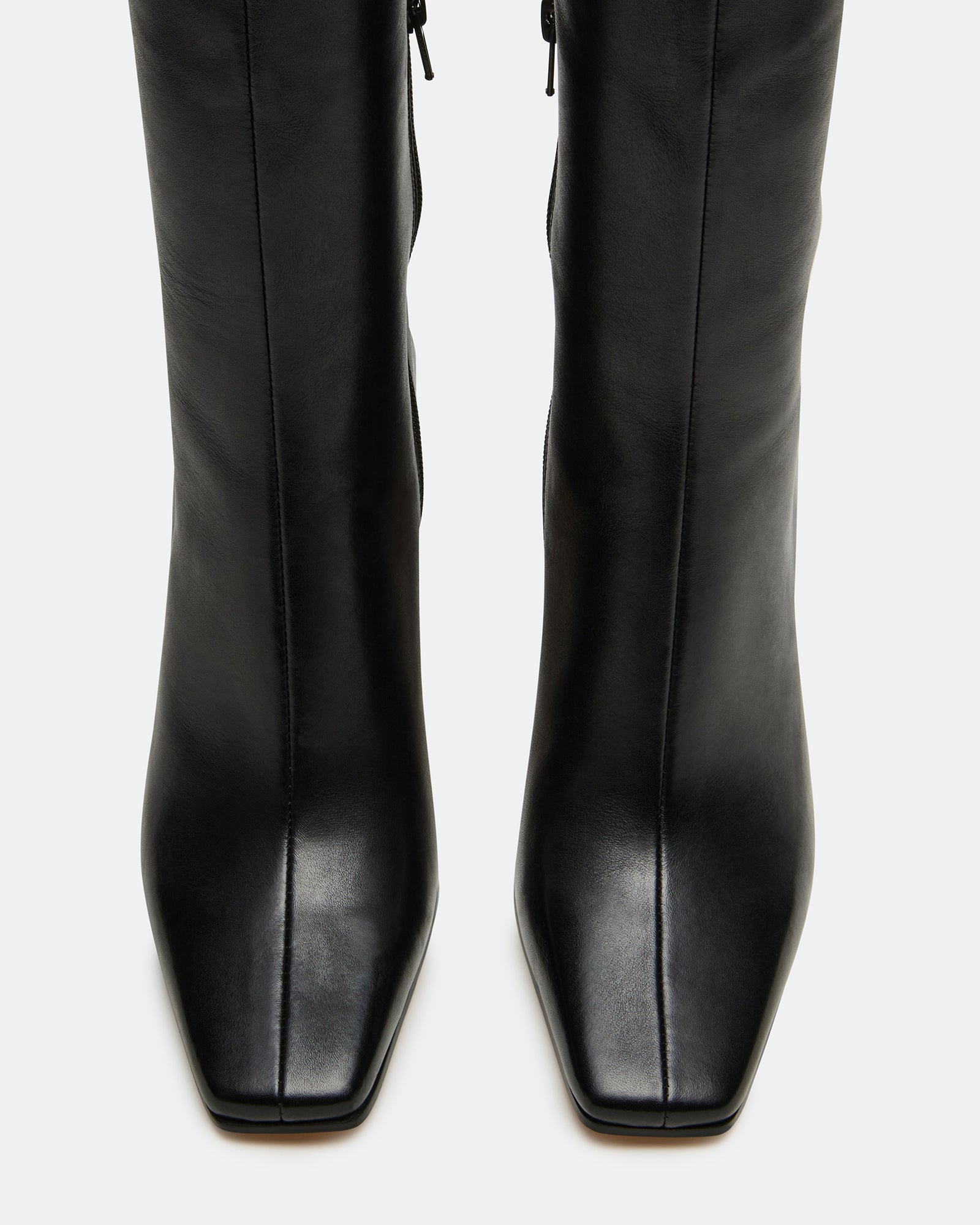 Close-up of the textured leather and square toe design on these knee-high boots.
