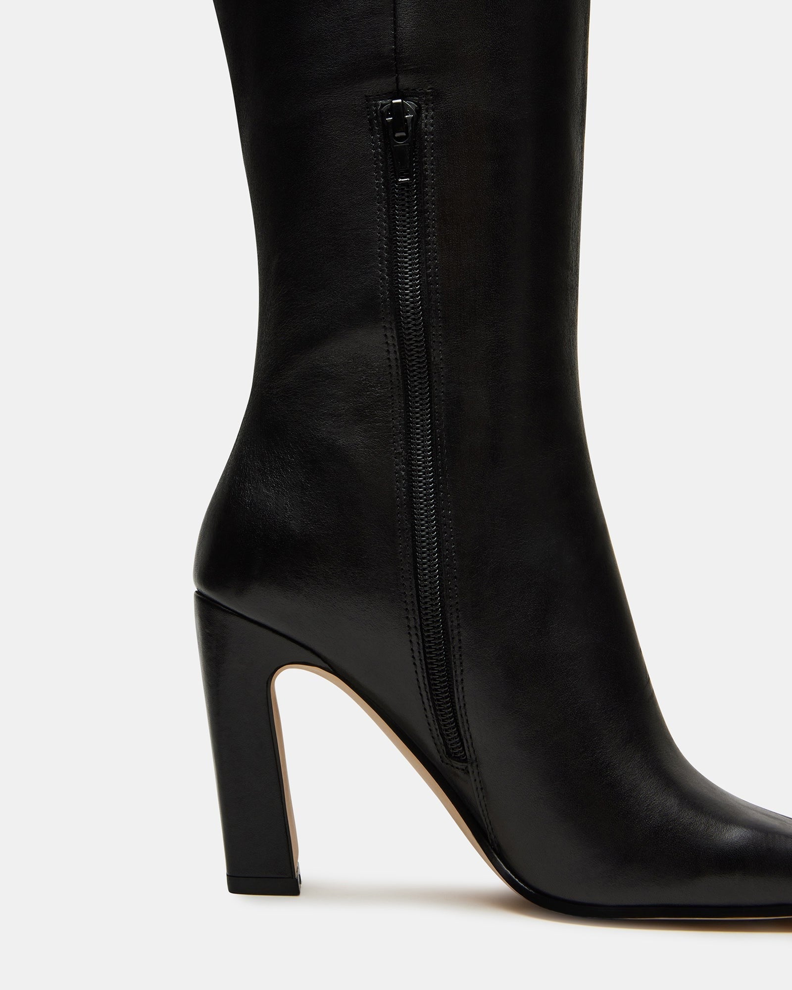 Lizette black leather boots styled with skinny jeans for a chic urban look.