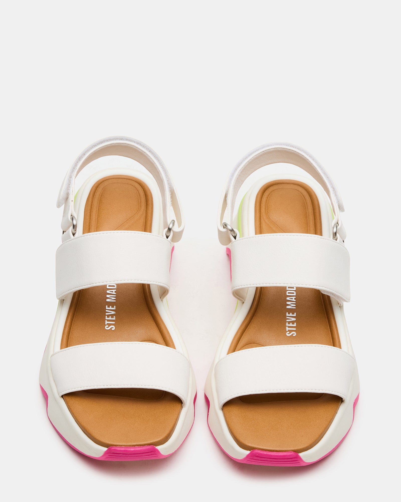 Black strappy sandals with gold accents, styled on a wooden deck.