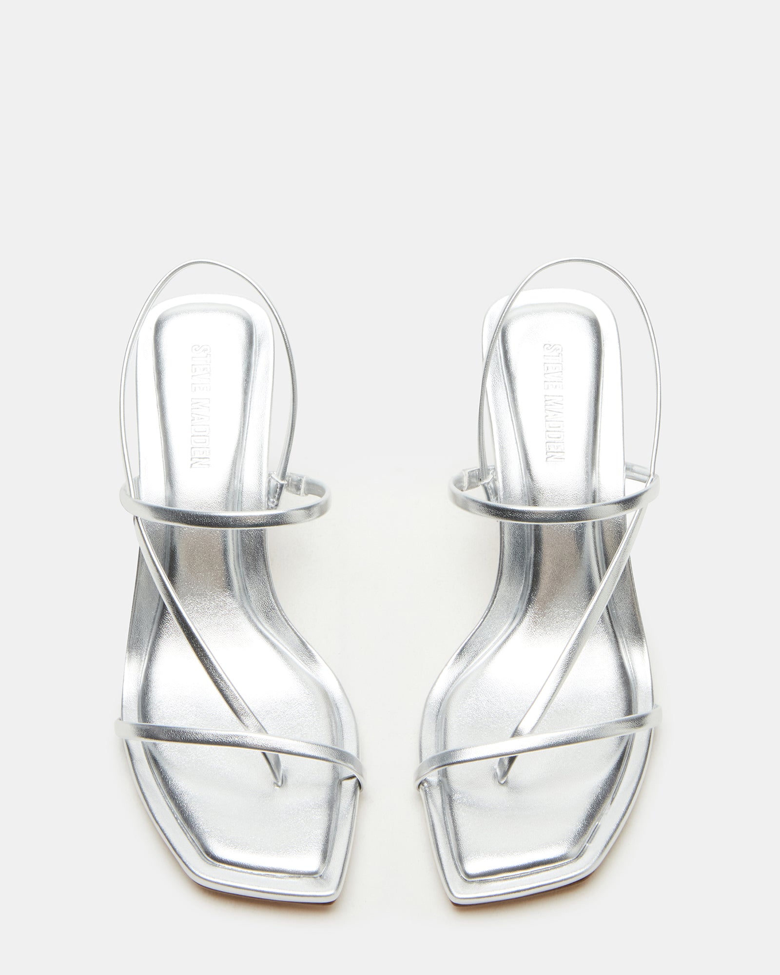 Close-up of vegan leather strappy detailing on white heels