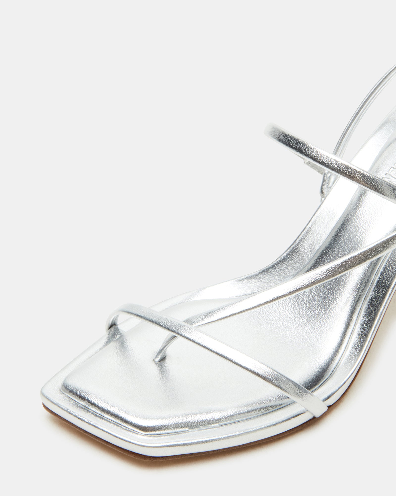 Locke silver square toe heels styled with black tailored pants