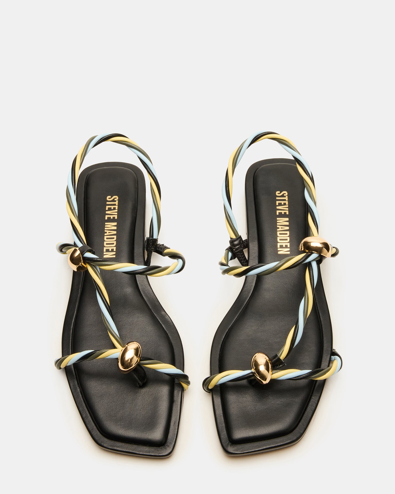 Close-up of black strappy sandals showcasing the vegan leather material.