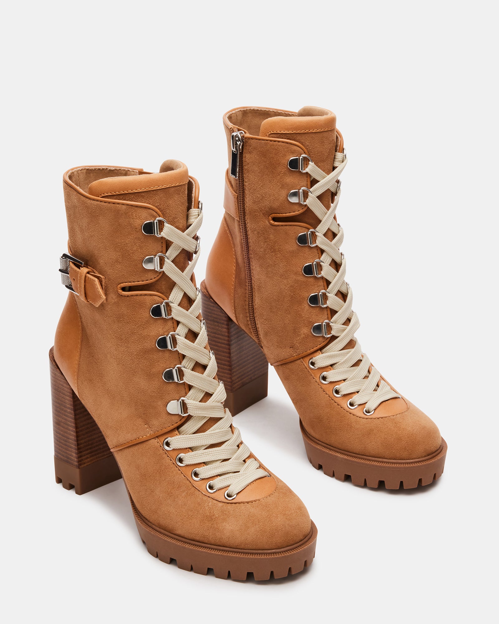 Close-up of lace detailing on black booties with heel for women.