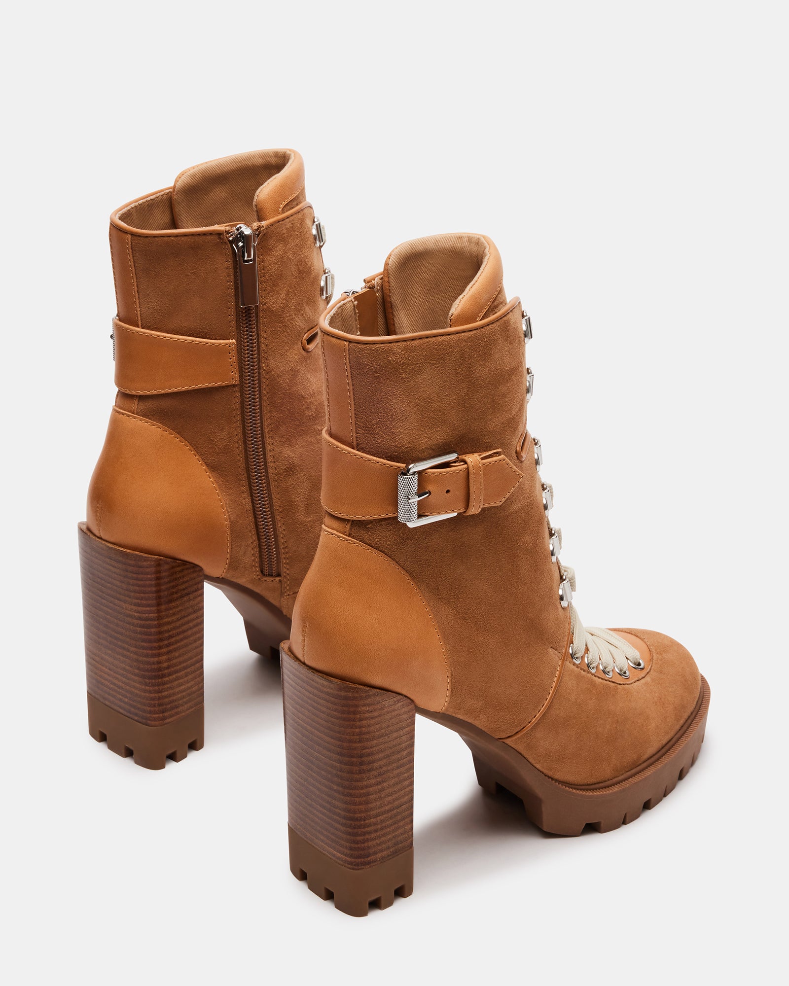 Close-up of lace detailing on black booties with heel for women.