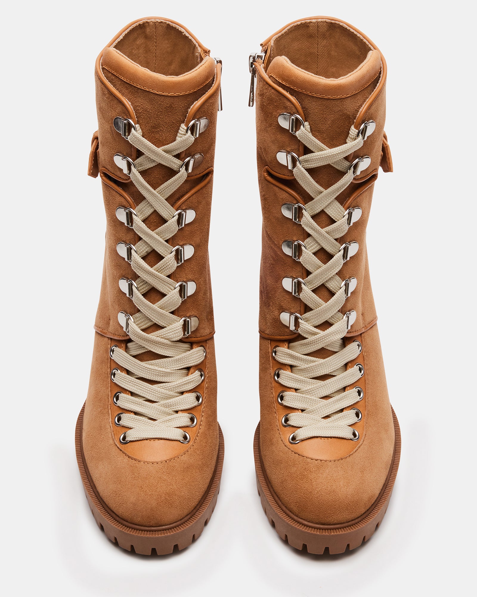 Side view of Londra lace-up heeled ankle booties against a rustic background.