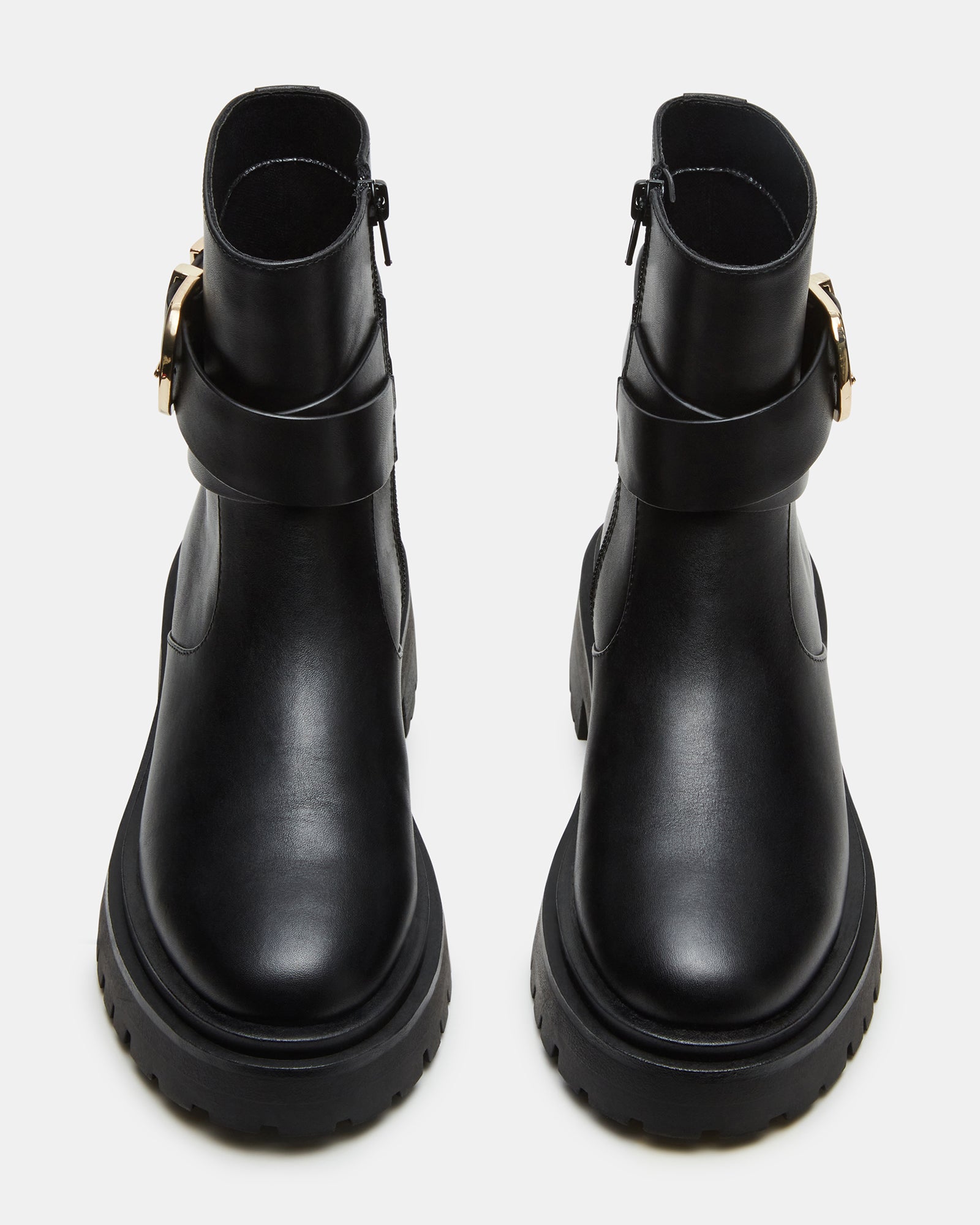 Close-up of durable lug sole on black leather boots.