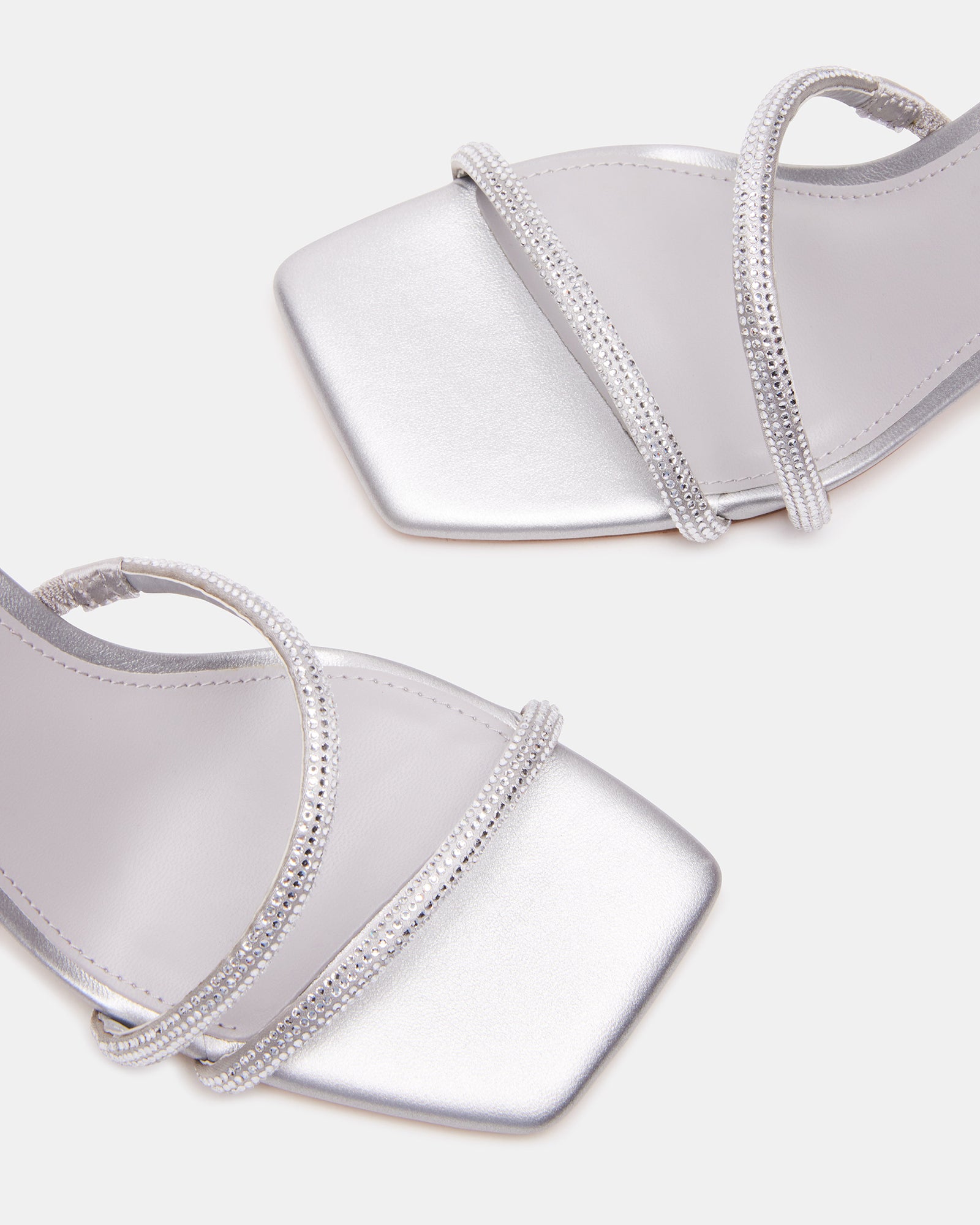 Close-up of the rhinestone detailing on the black block heel sandals.