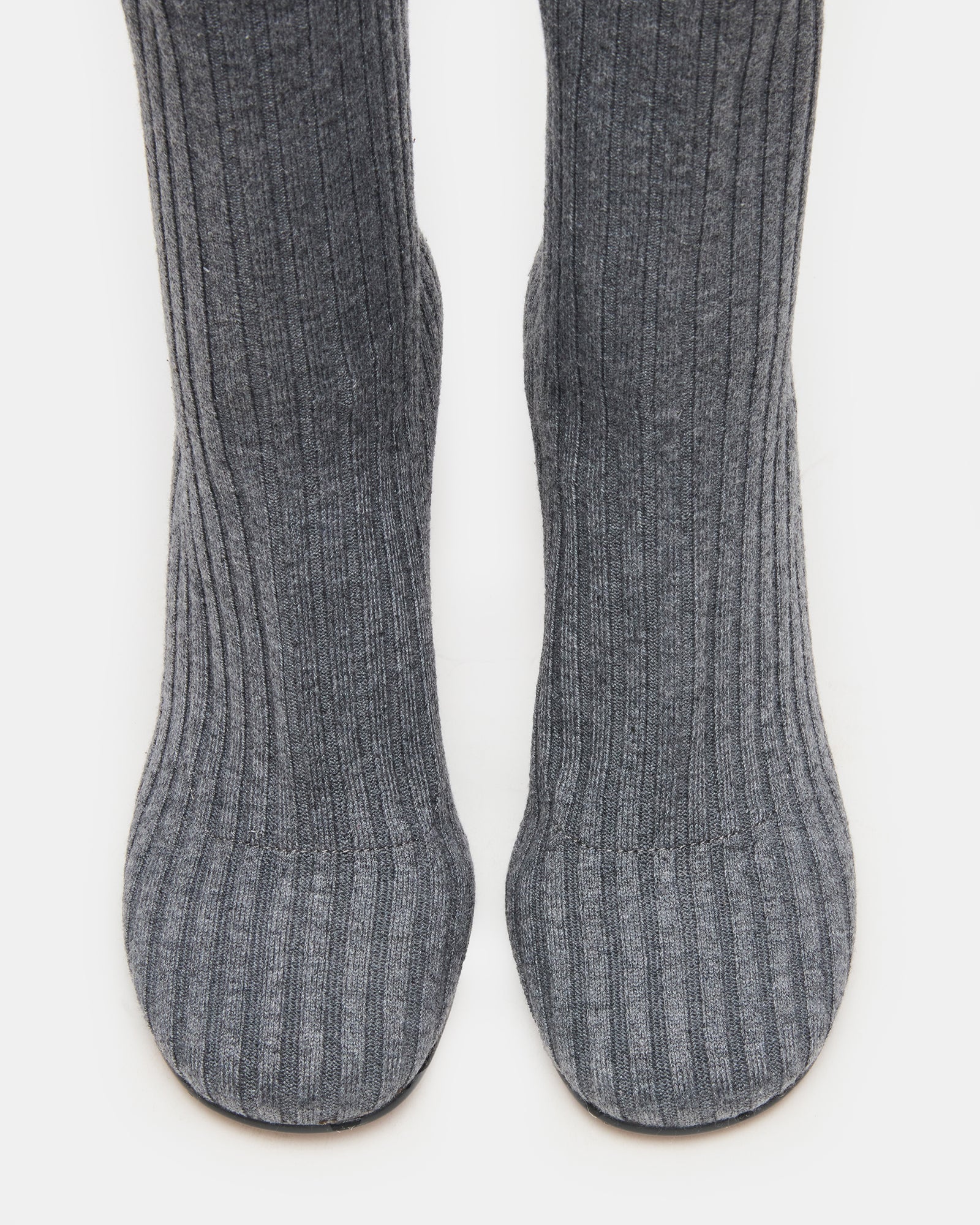Side view of heeled booties showing textured knit and soft curve around ankle